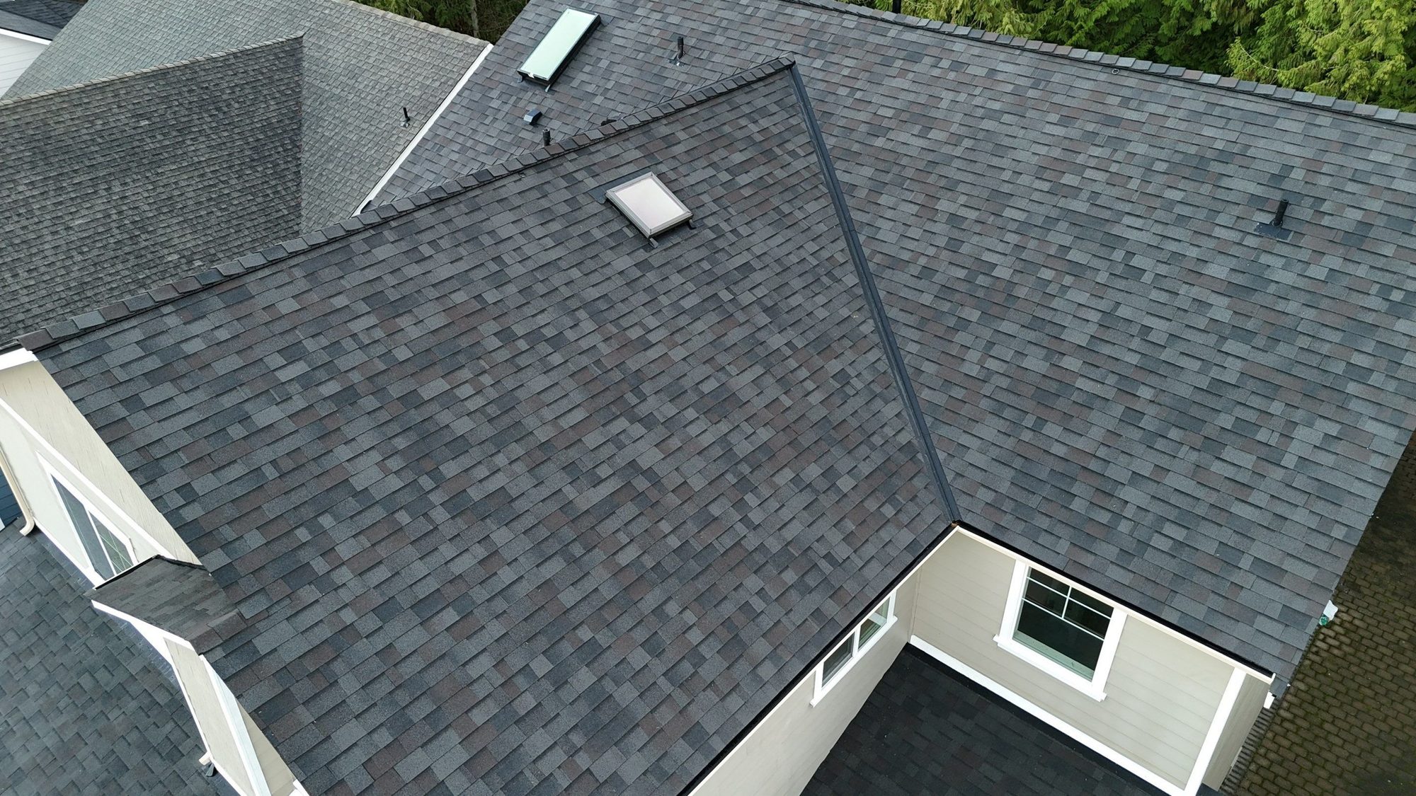 Drone view over the completed Malarkey Vista Black Oak asphalt shingle roof with skylight and dormer, Snohomish, WA, by Amor Roofing