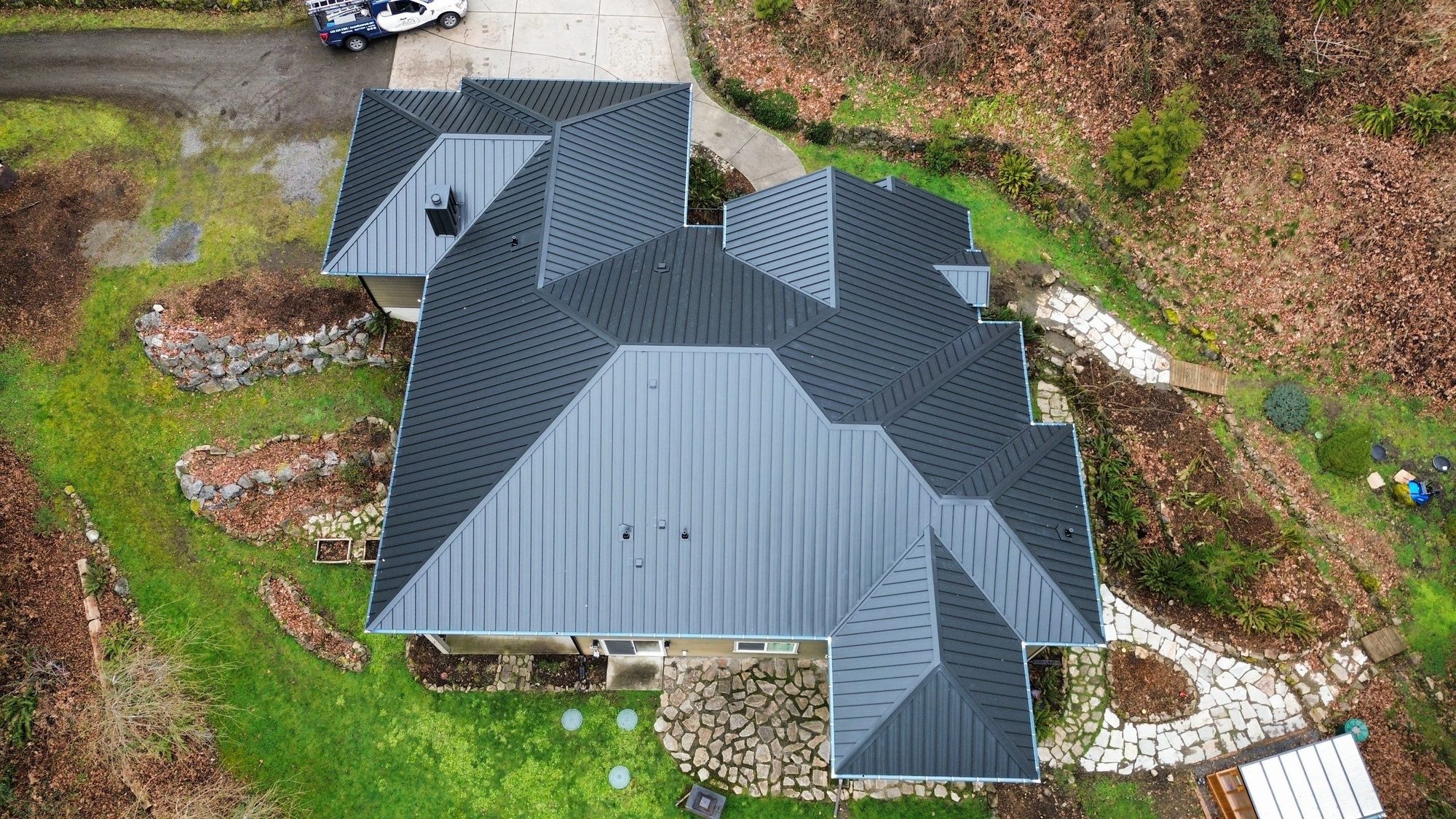 Amor Roofing Matte Black metal roof in Snohomish, full house aerial drone wide