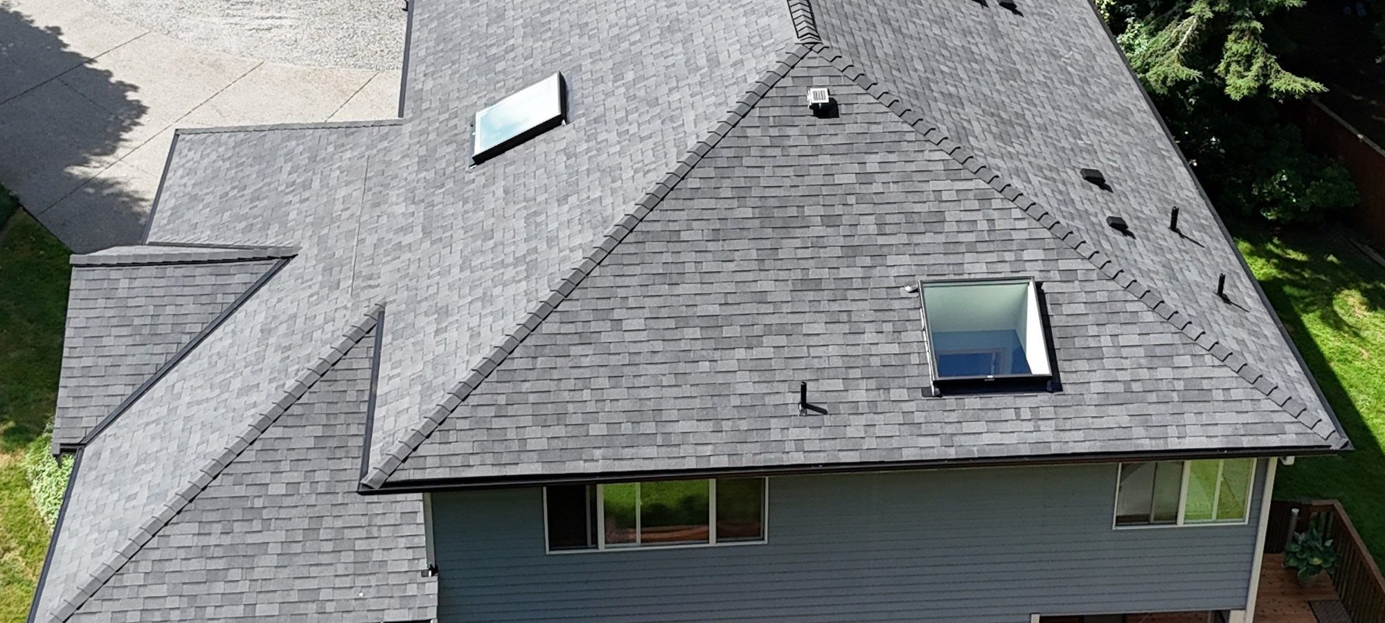 Drone view of the finished Malarkey Legacy Midnight Black asphalt shingle roof with new skylights, Lake Stevens, WA, by Amor Roofing