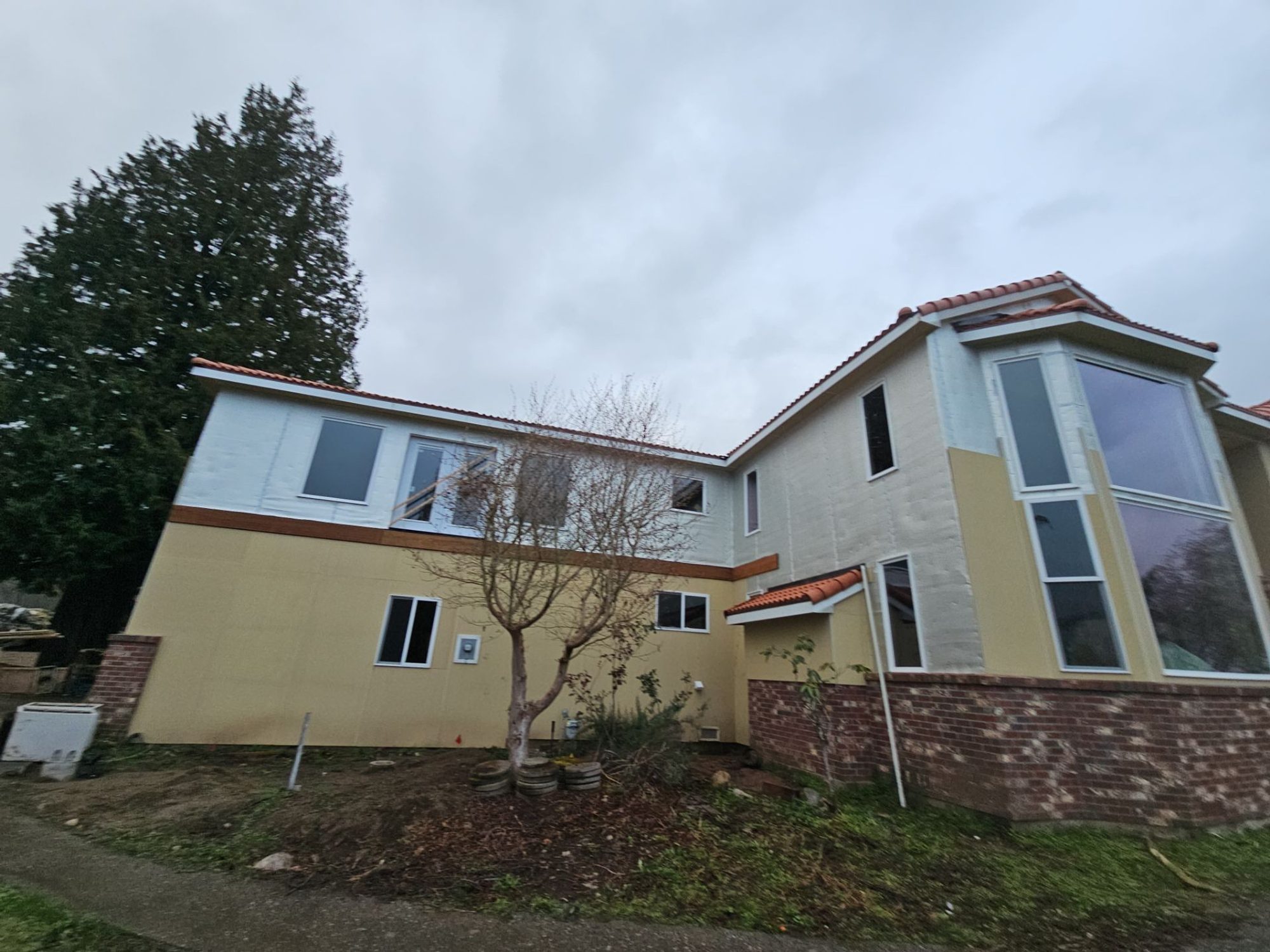 Two-story Mukilteo, WA home with its new Antique Clay Brava composite Spanish barrel tile roof, from the front