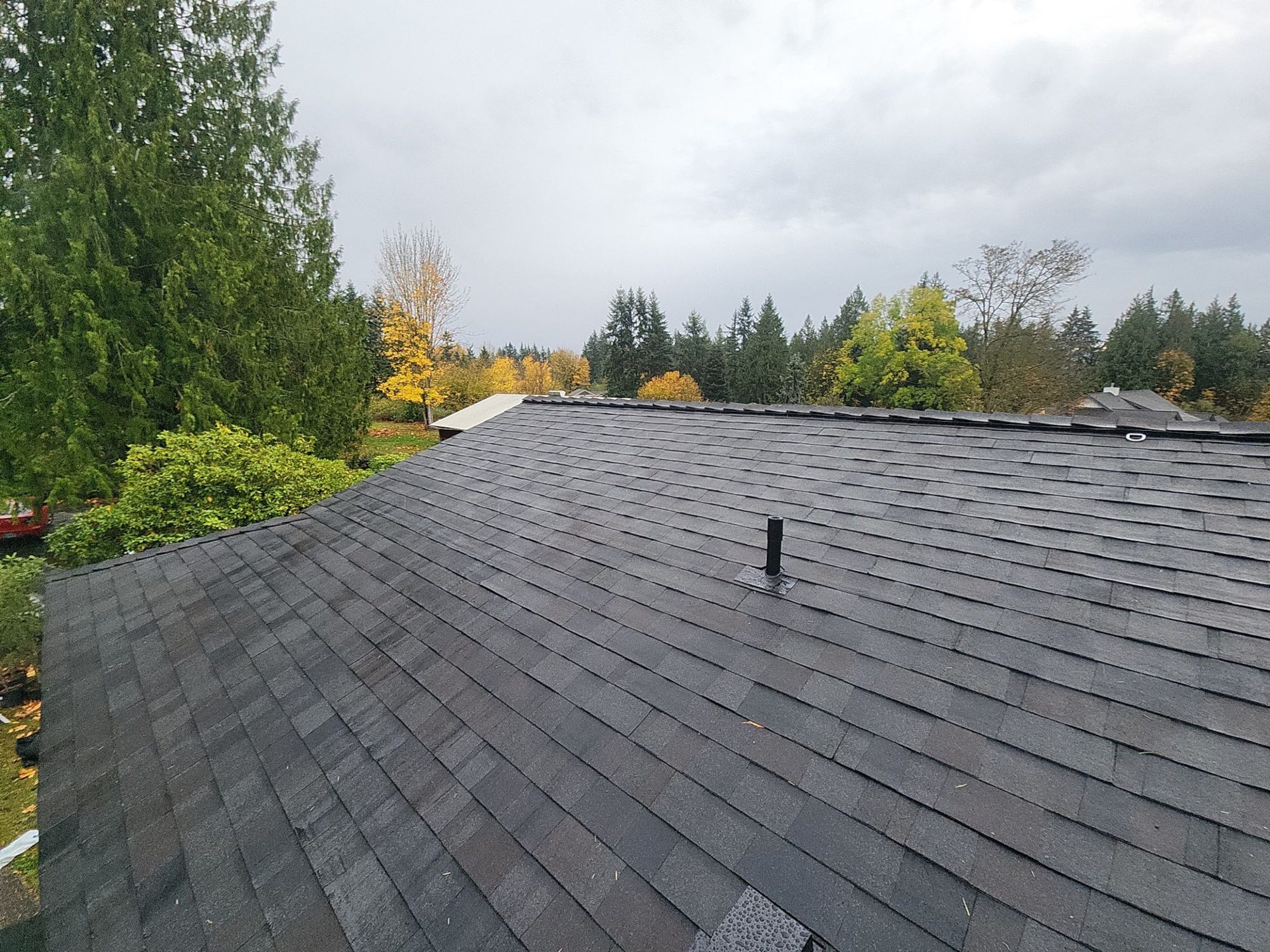 Wide view across the finished Black Oak roof plane and vent, Snohomish