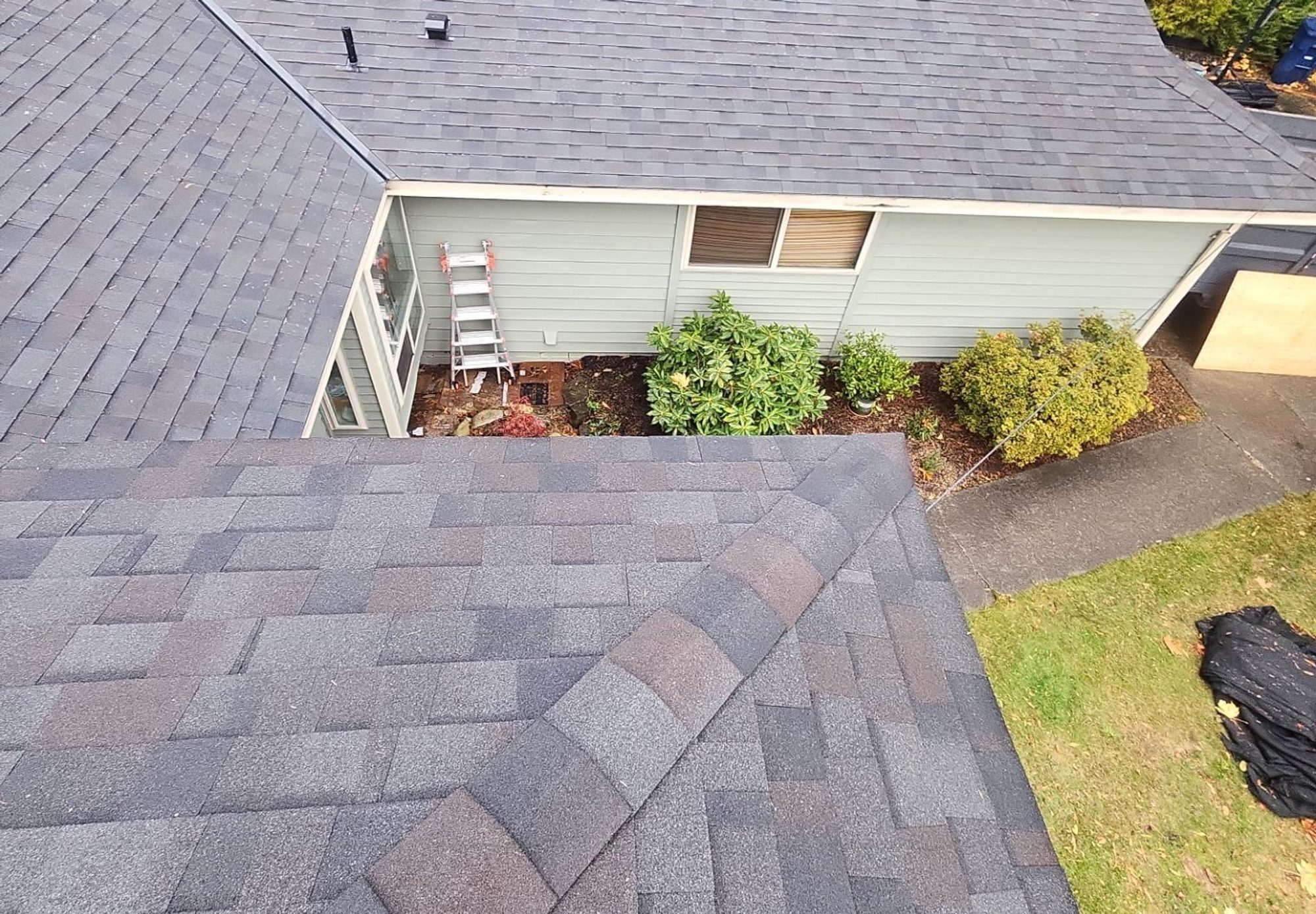 Looking down the finished Black Oak asphalt roof to the side of the two-story Snohomish home