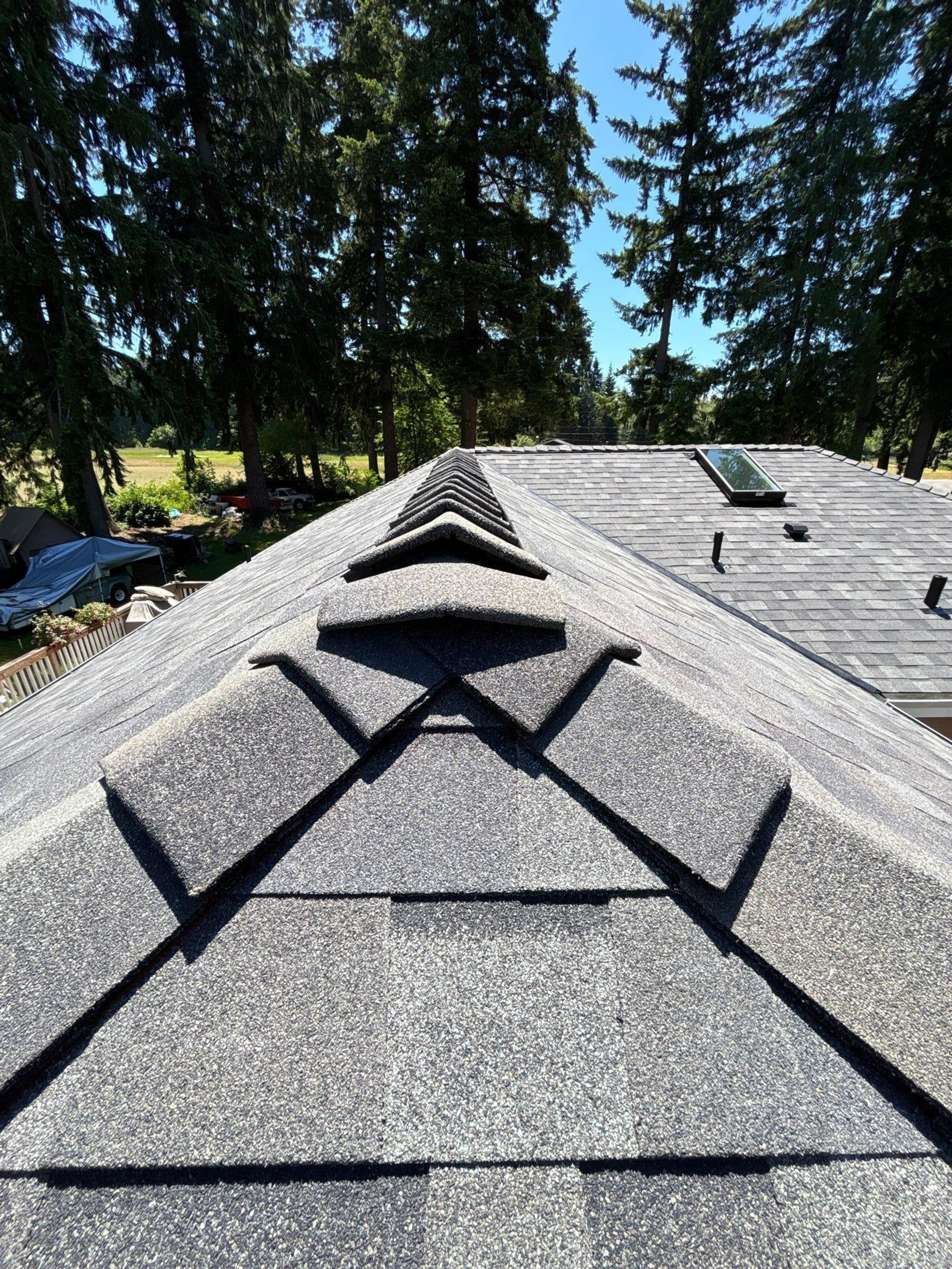 Ridge caps running up the hip of the finished Malarkey Storm Grey roof, Lake Stevens, WA