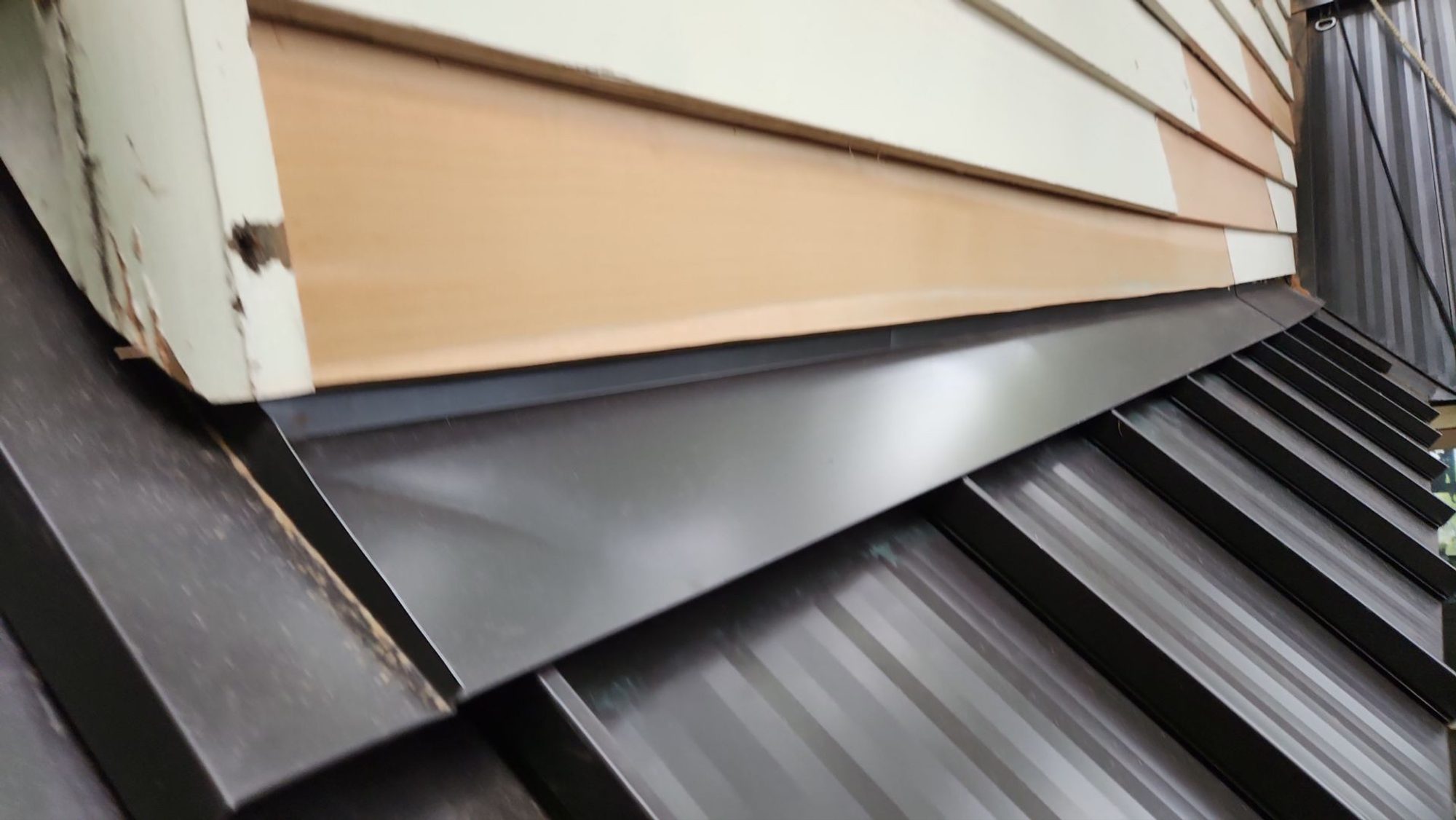 Standing seam panels of the Dark Bronze standing seam metal roof with the lake in the distance, Bellevue, WA
