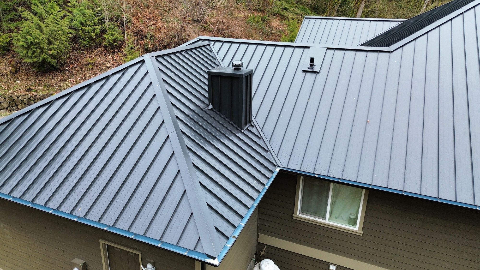 Amor Roofing Matte Black metal roof in Snohomish, chimney vent stack detail