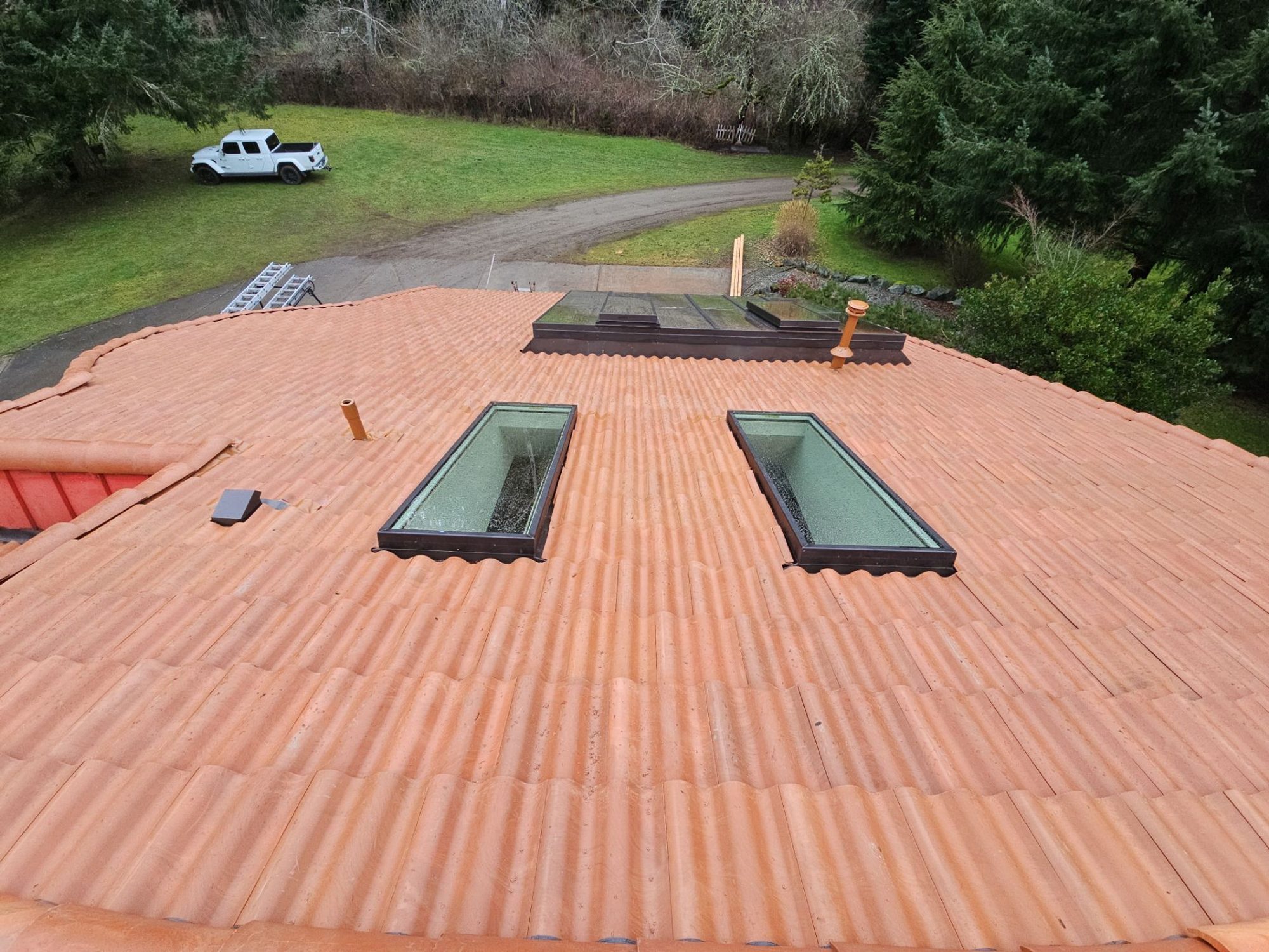 Pair of skylights set into the finished Antique Clay Brava composite Spanish barrel tile roof, Camano Island, WA