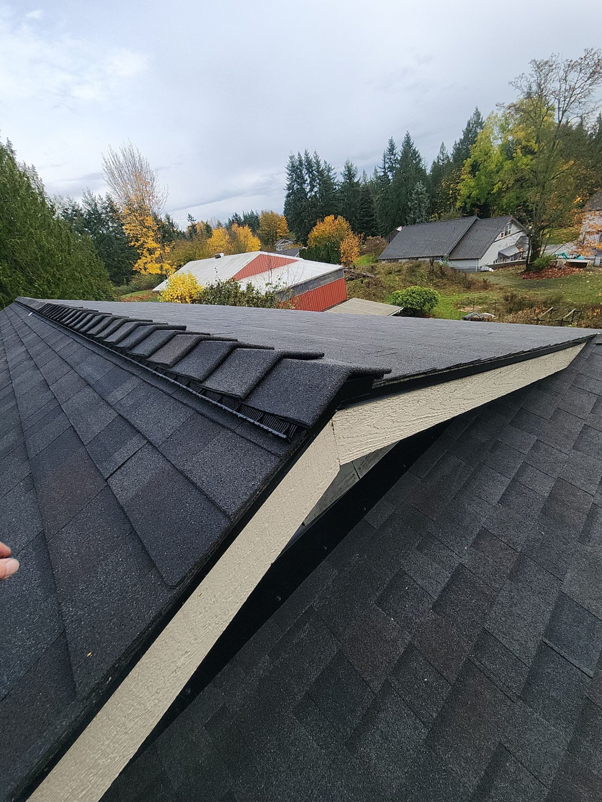 Ridge cap and gable end detail on the finished Black Oak asphalt roof, Snohomish