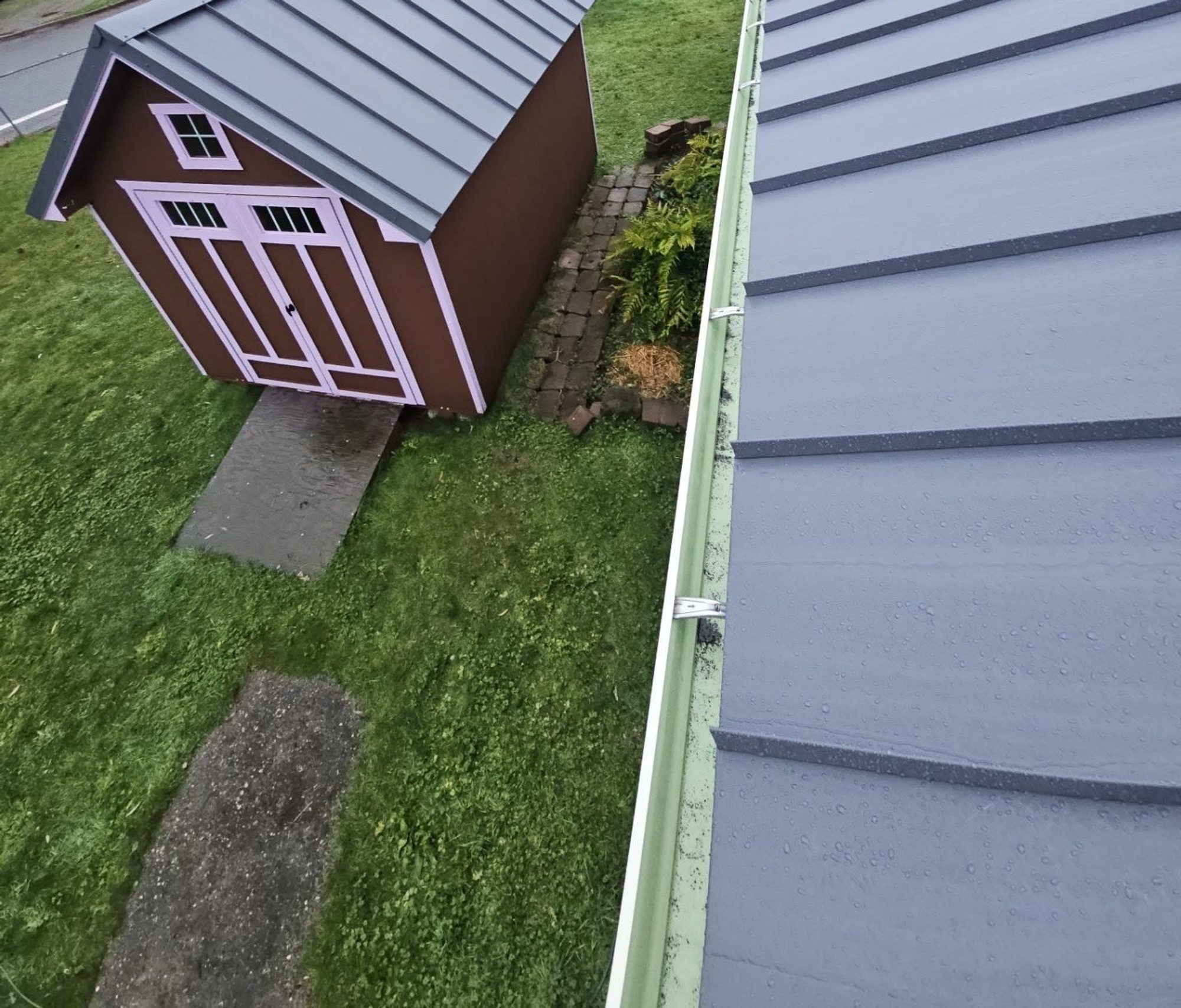 Finished Cascade Gray standing seam metal roof with the matching shed roof below, Woodinville, WA
