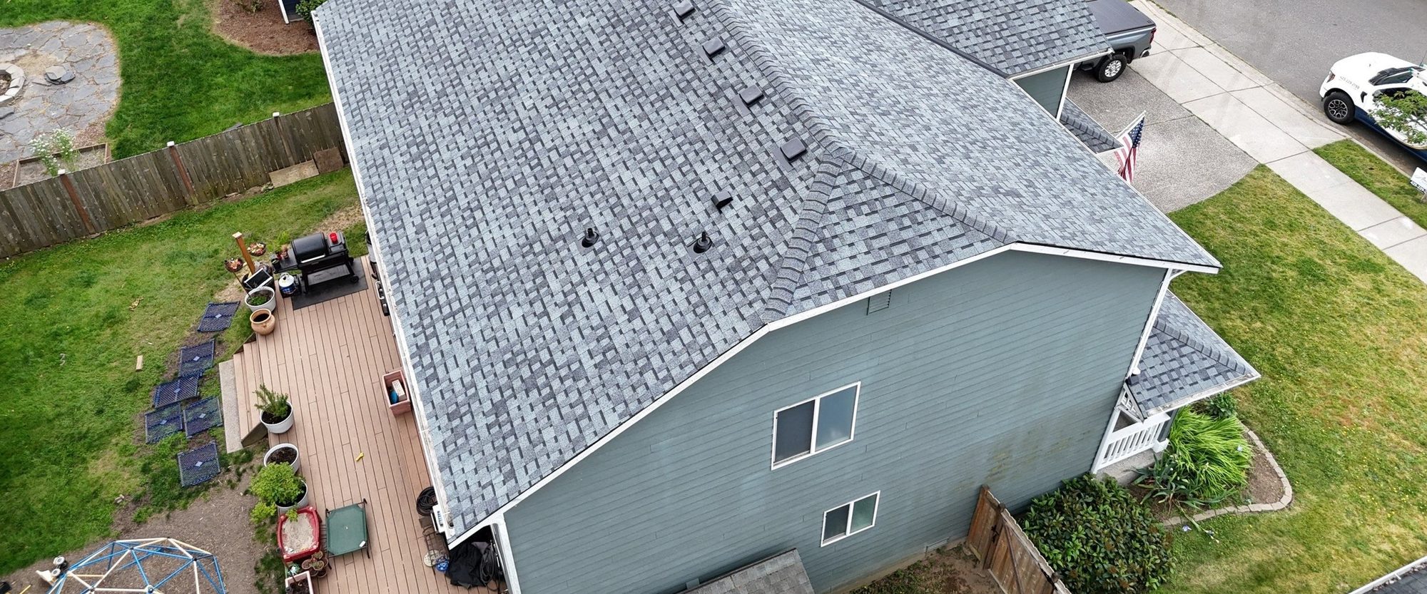 Rear aerial of the finished Pabco Premier Pewter Gray asphalt shingle roof above the deck, Marysville, WA