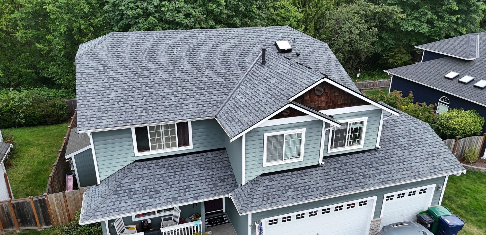 Front aerial of the finished Pabco Premier Pewter Gray asphalt shingle roof over the porch and garage, Marysville, WA
