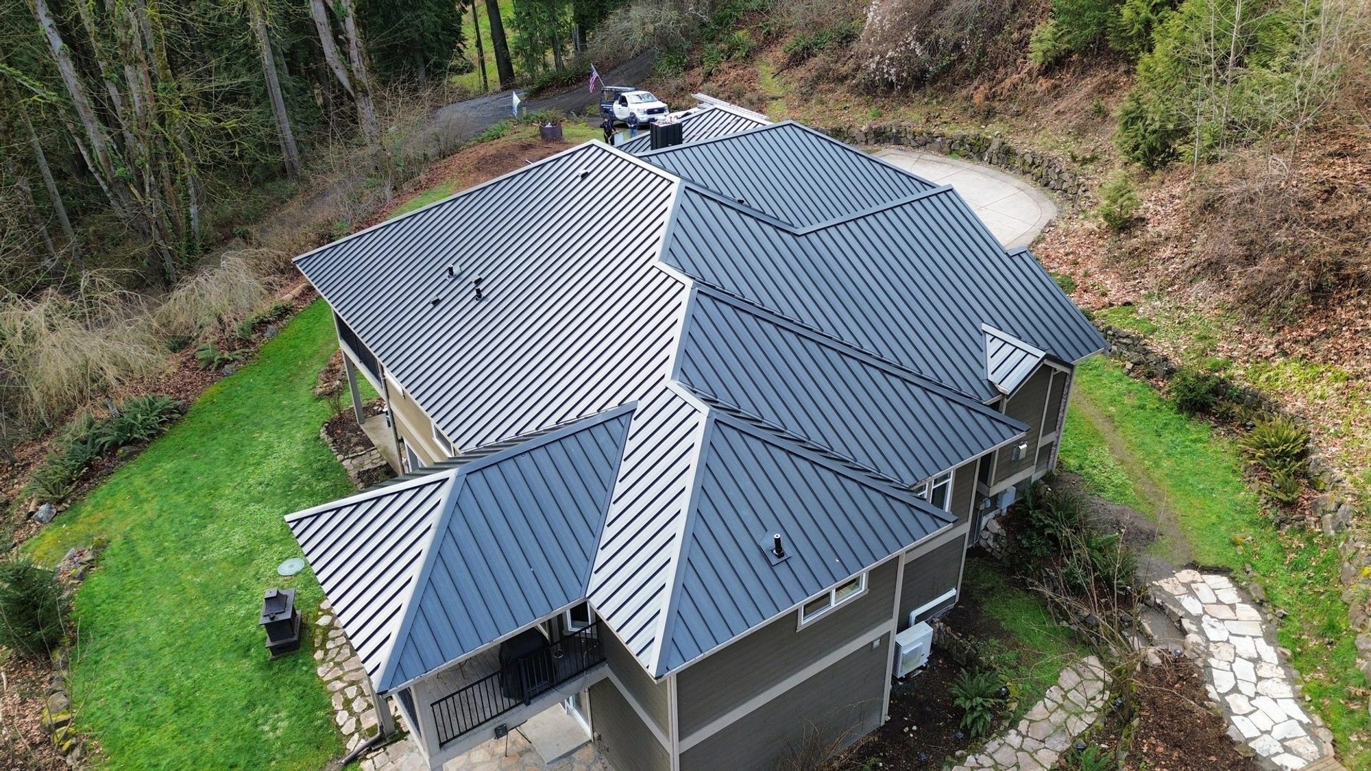 Aerial drone view of completed Matte Black standing seam metal roof on Snohomish, WA home by Amor Roofing