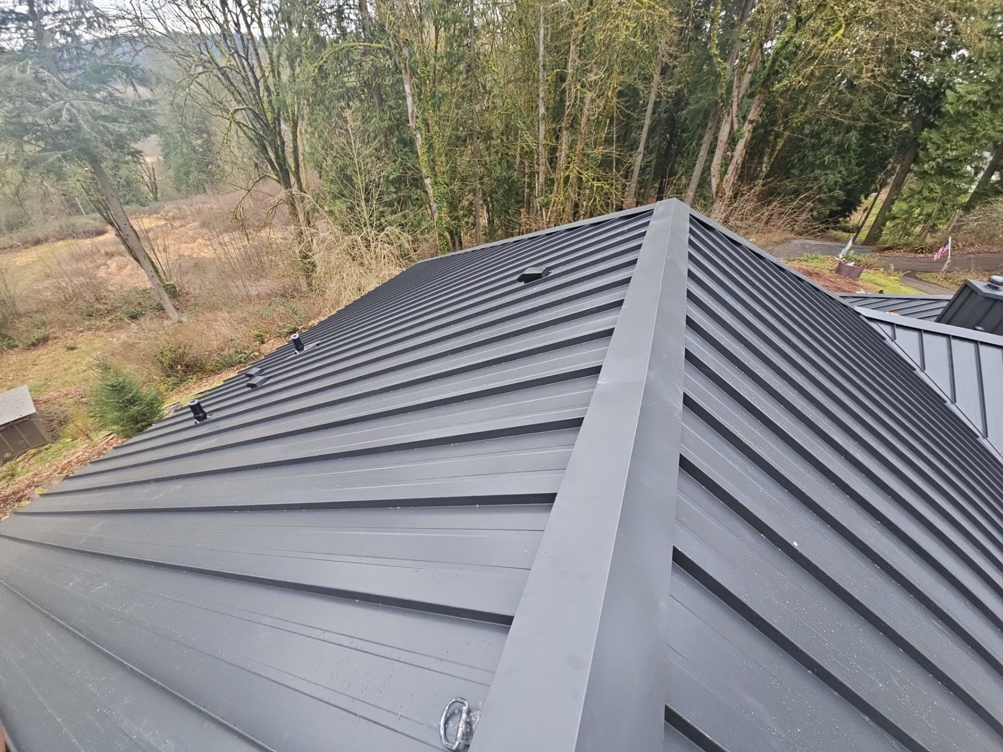 Amor Roofing Matte Black metal roof in Snohomish, long seam runs matte black