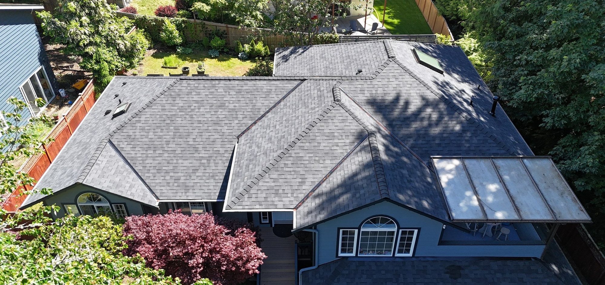 Aerial over the front of the home and its finished Malarkey Vista Midnight Black asphalt shingle roof, Edmonds, WA