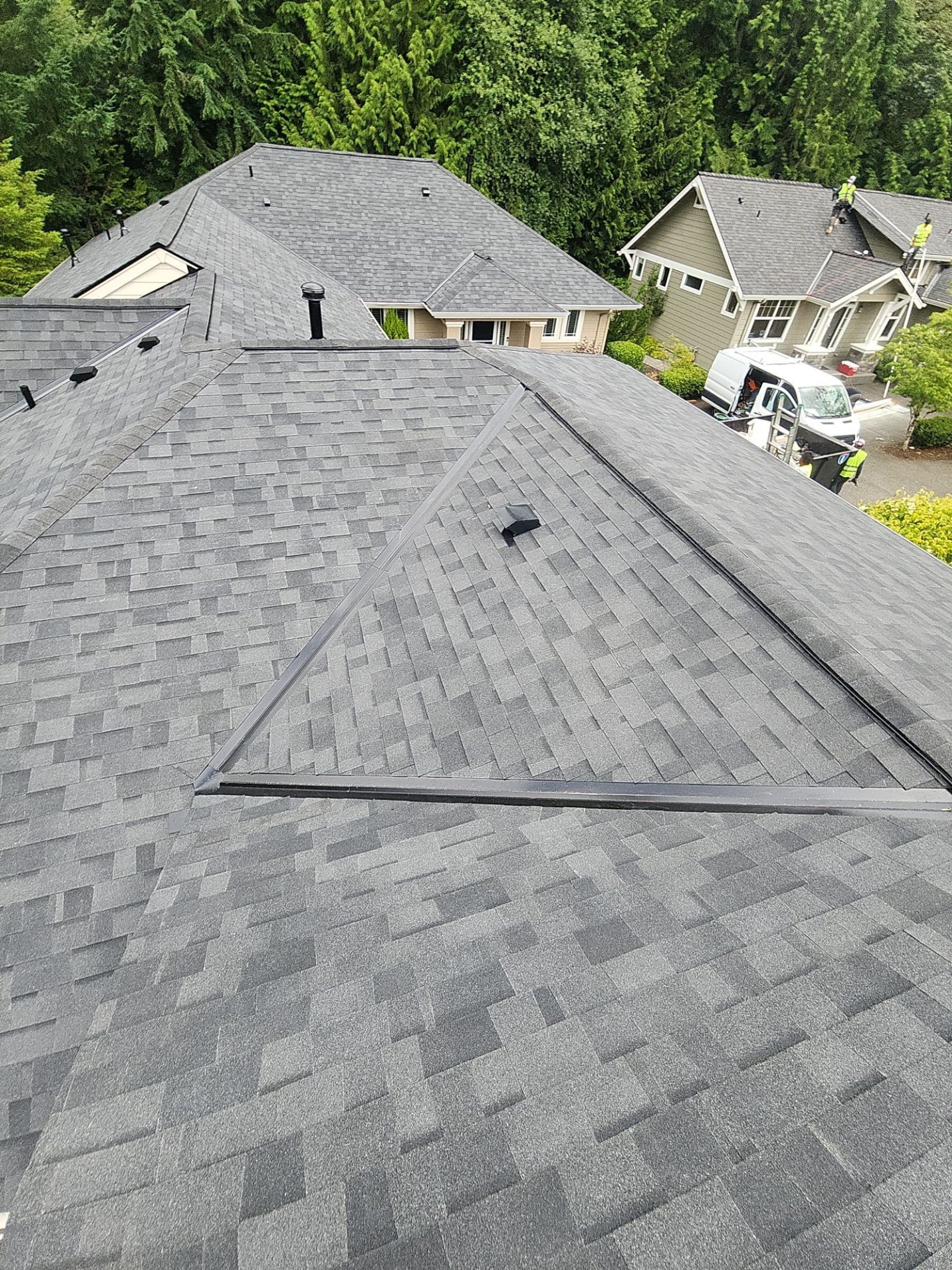 Peak of the Malarkey Highlander Midnight Black asphalt shingle roof with pipe boots and vent, Redmond, WA