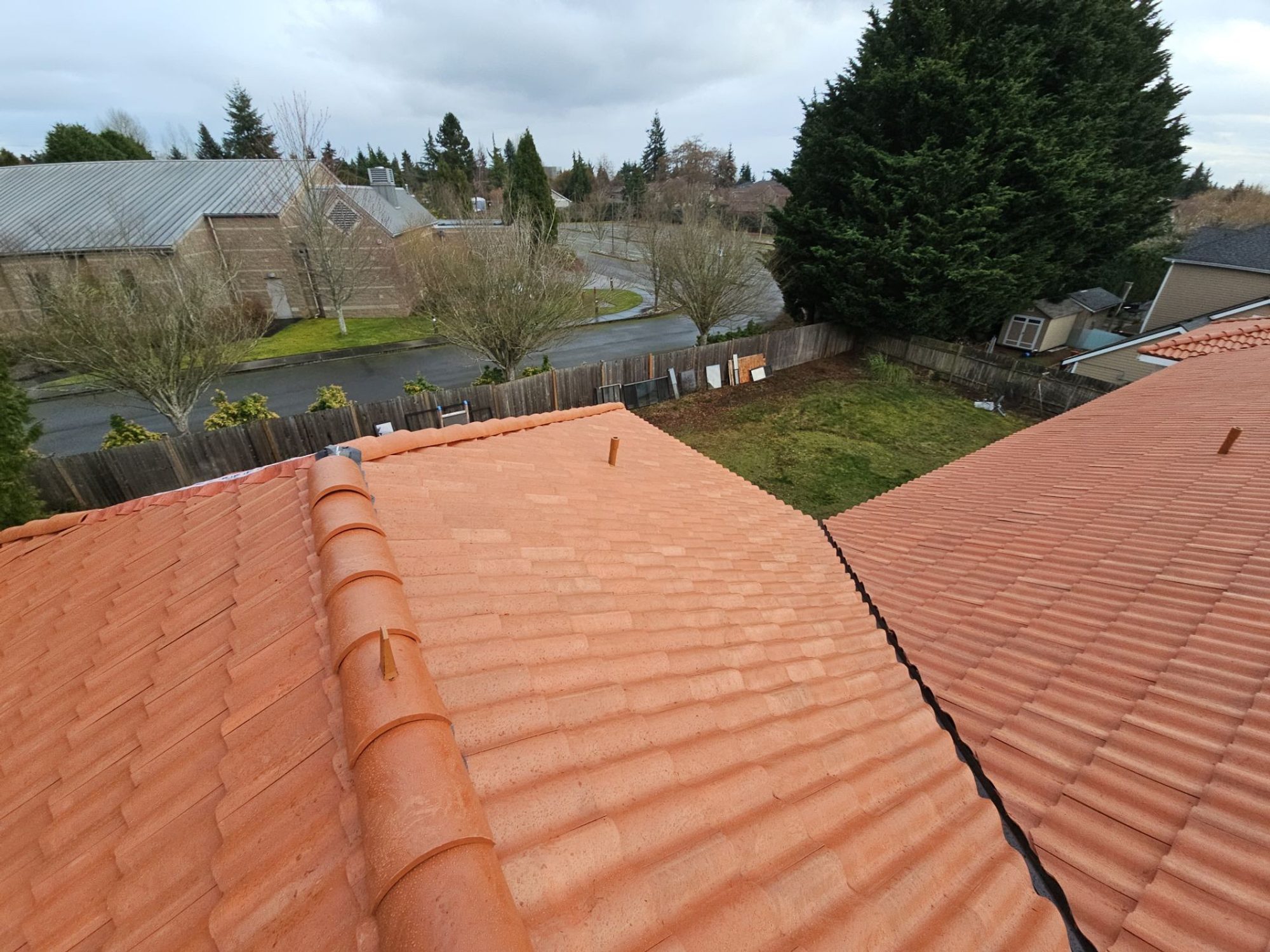 Ridge caps on the Antique Clay Brava composite Spanish barrel tile roof over the neighboring homes, Mukilteo, WA
