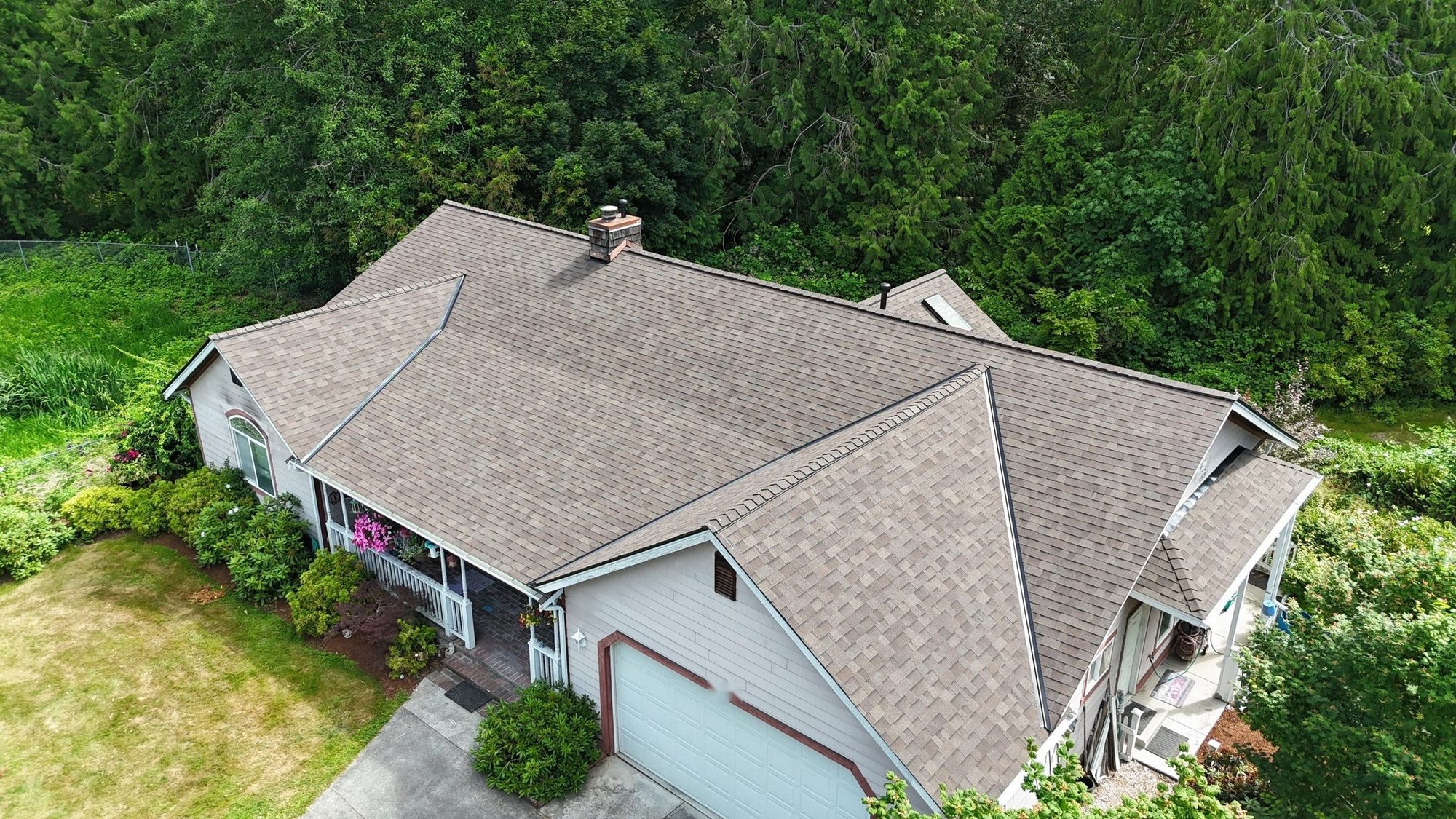 Angled aerial of the finished Malarkey Heather Grey asphalt shingle roof over the front porch and garage, Lake Stevens, WA