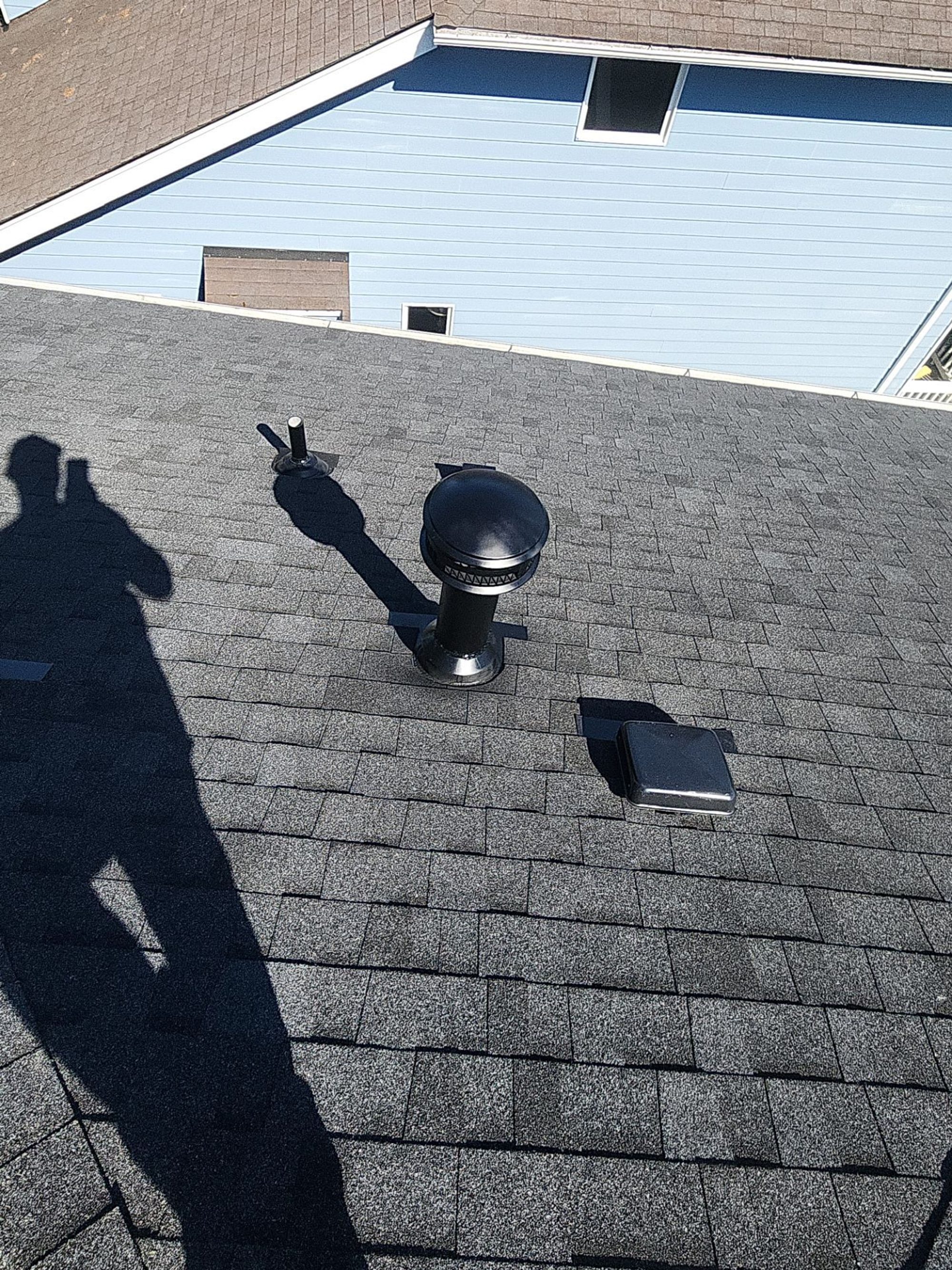 Box vents and skylight on the Pabco Premier Antique Black asphalt shingle roof looking toward the neighborhood, Bothell, WA