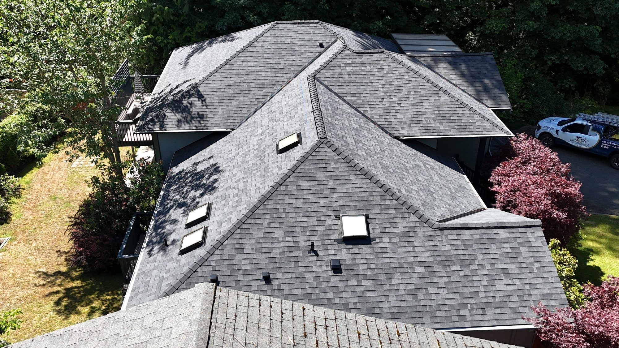 Overhead view of the roof planes and skylights in Midnight Black shingles, Edmonds