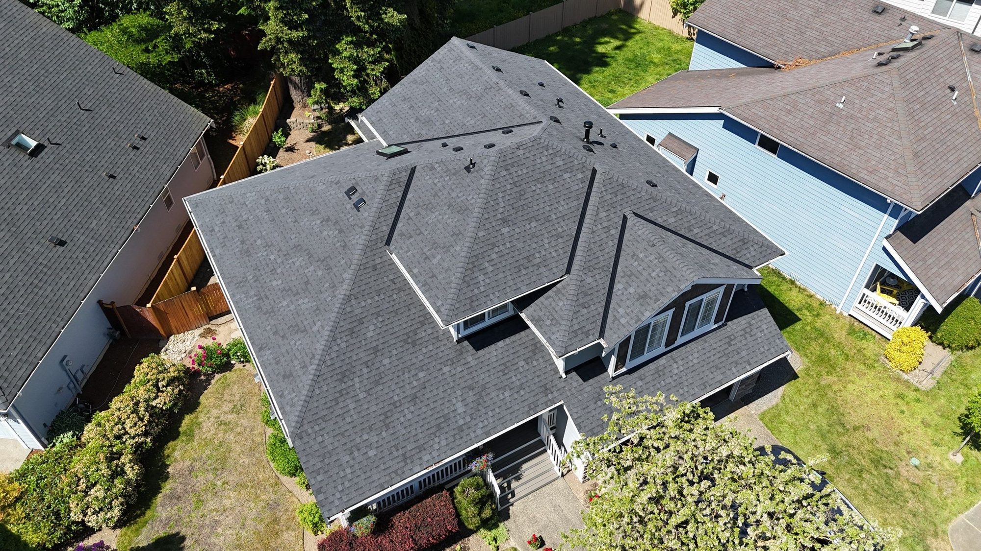 Aerial over the front of the home and its finished Pabco Premier Antique Black asphalt shingle roof, Bothell, WA