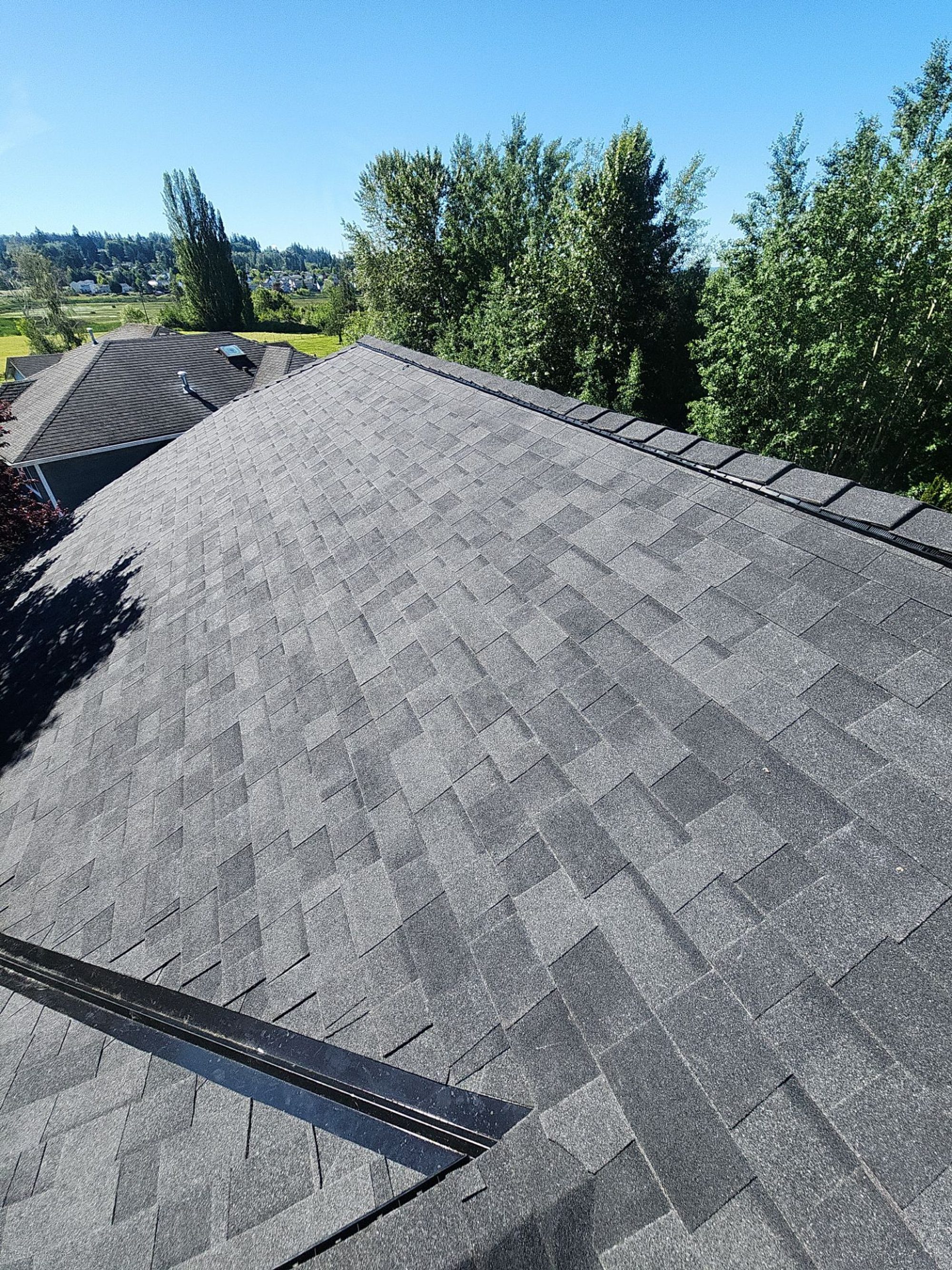 Amor Roofing Midnight Black asphalt roof in Marysville, aerial lake view