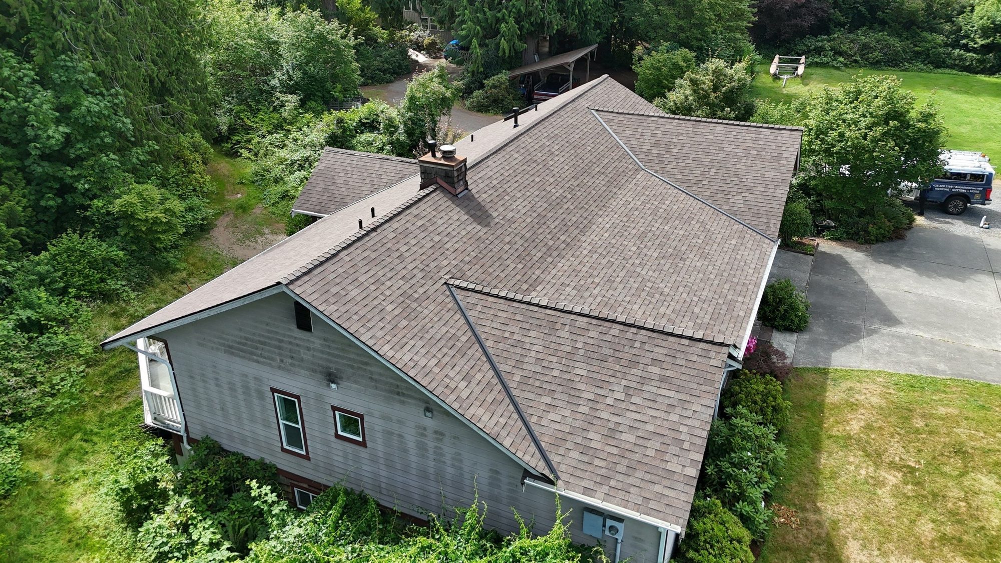 Rear aerial of the finished Malarkey Heather Grey asphalt shingle roof with the chimney, Lake Stevens, WA