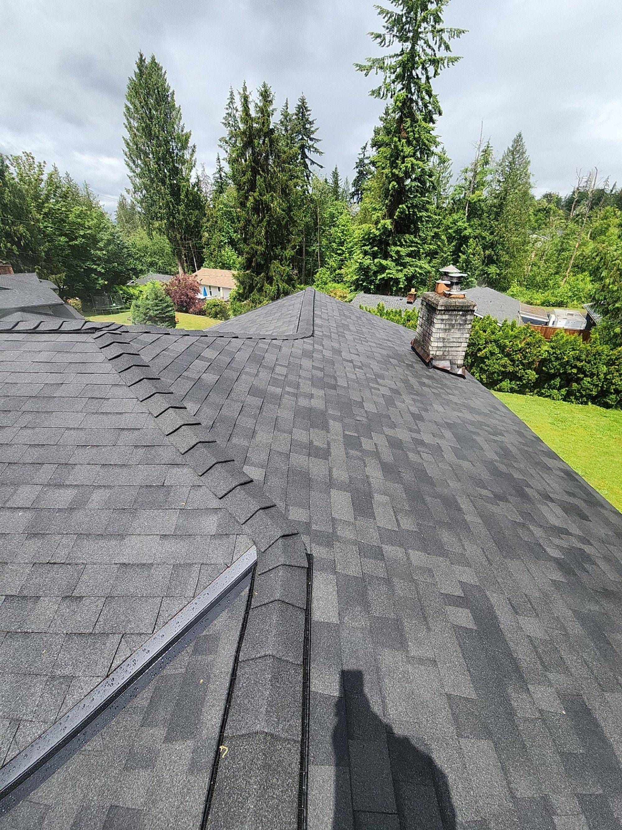 Amor Roofing Midnight Black asphalt roof in Lake Stevens, after roof ridge chimney