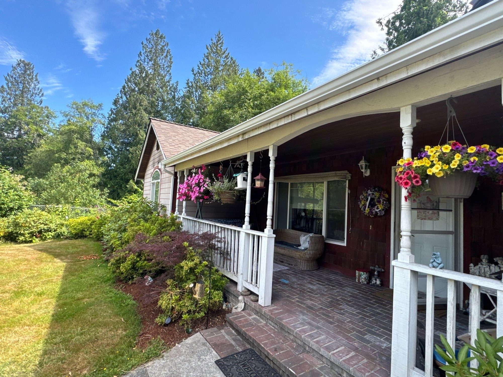 Front porch and eave of the finished Malarkey Heather Grey asphalt shingle roof with hanging baskets, Lake Stevens, WA