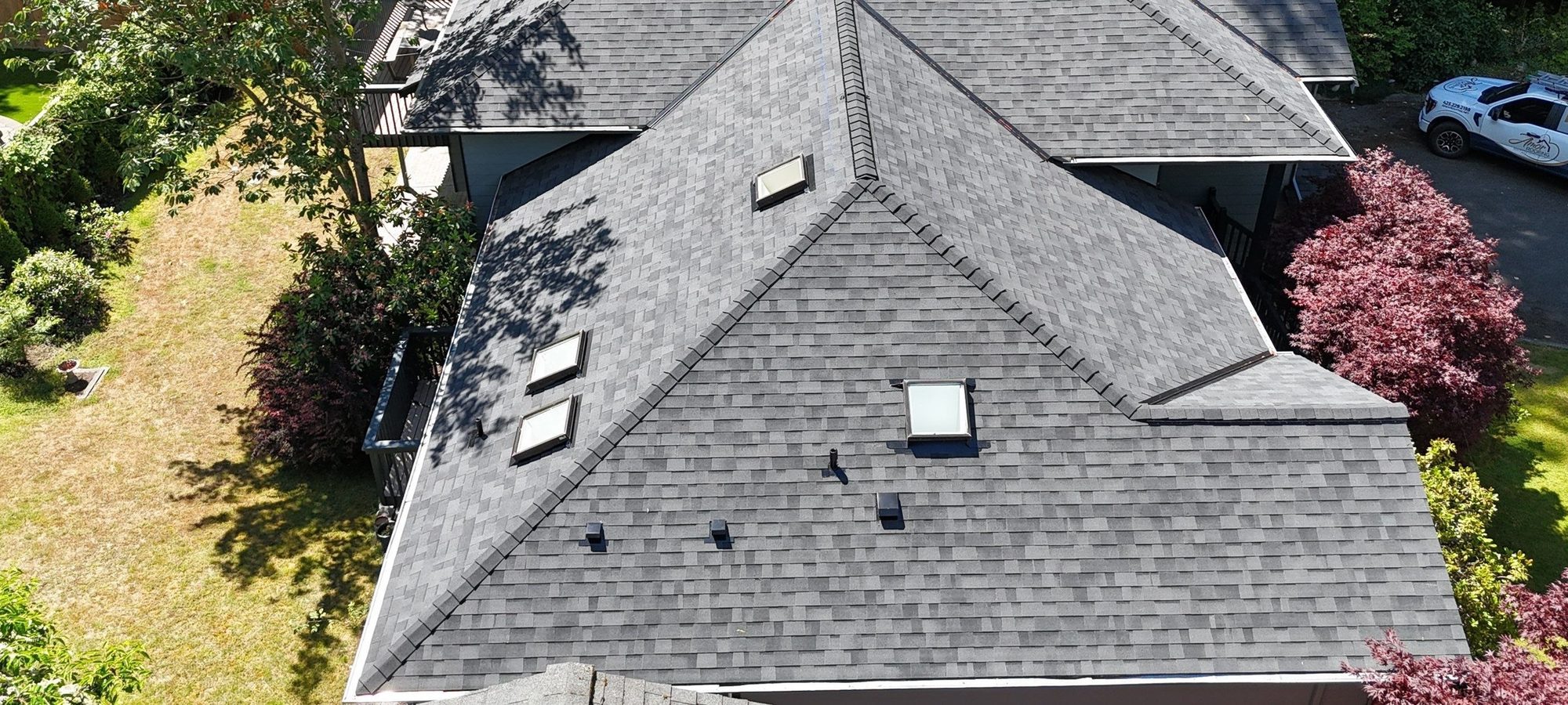 Aerial over the skylights of the finished Malarkey Vista Midnight Black asphalt shingle roof, Edmonds, WA
