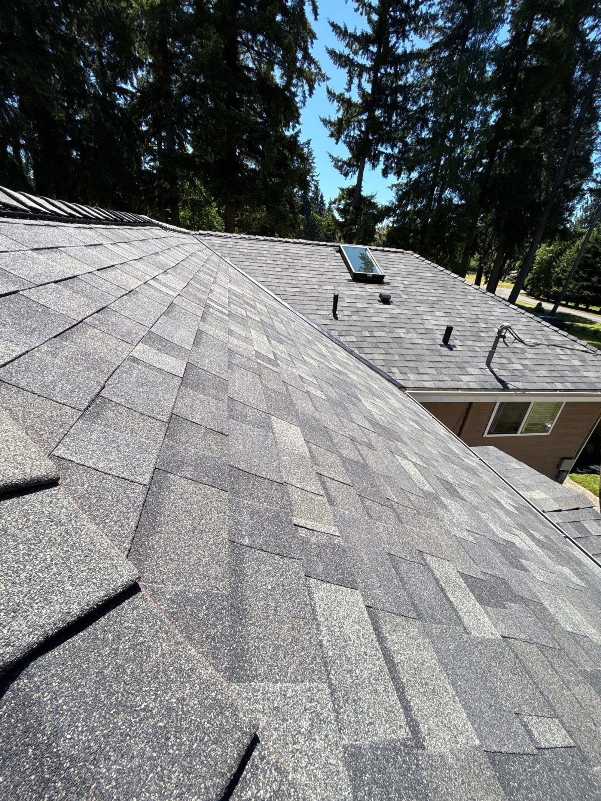 Finished Malarkey Storm Grey asphalt shingle roof with skylight and vents toward the neighboring gable, Lake Stevens, WA, by Amor Roofing