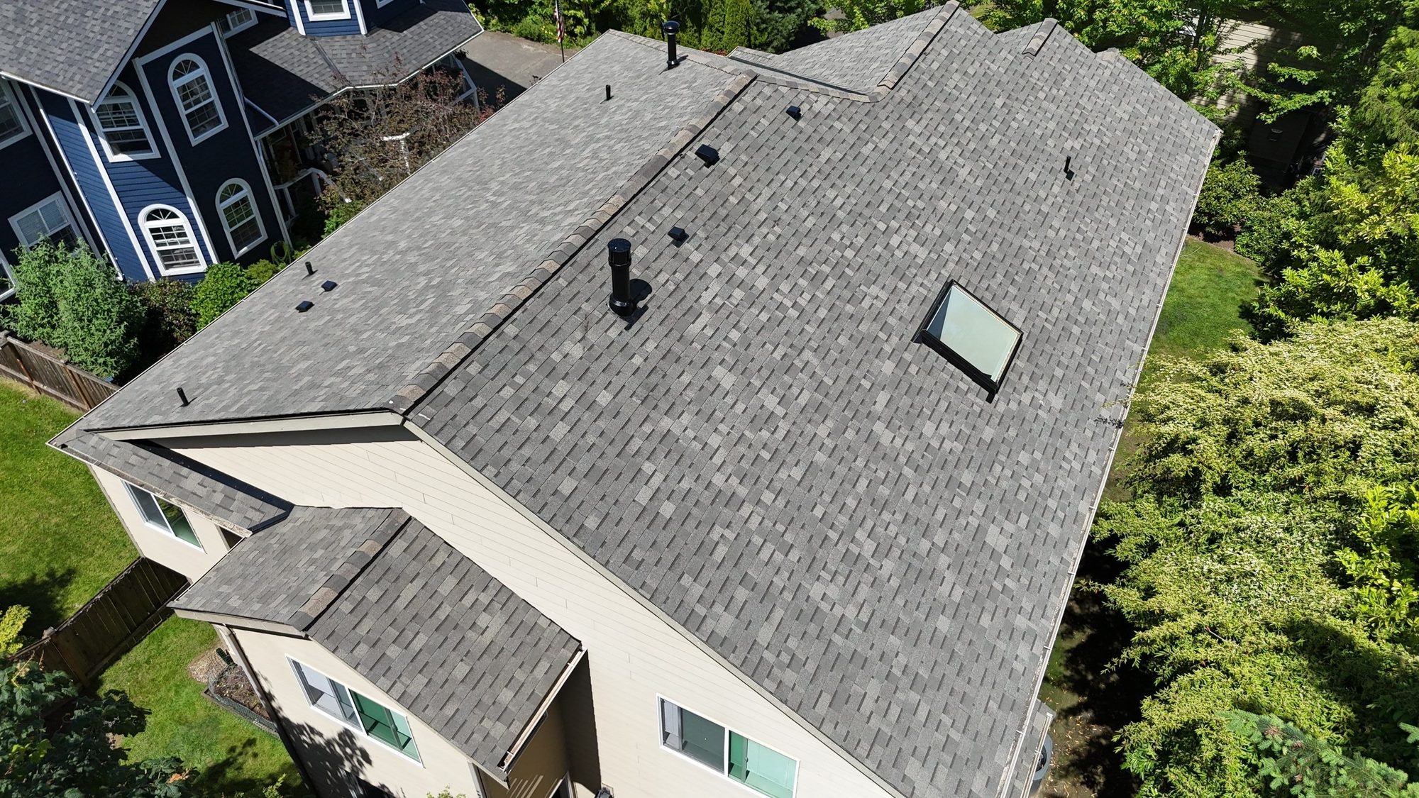 Amor Roofing Weathered Wood asphalt roof in Kenmore, drone overhead chimney skylight
