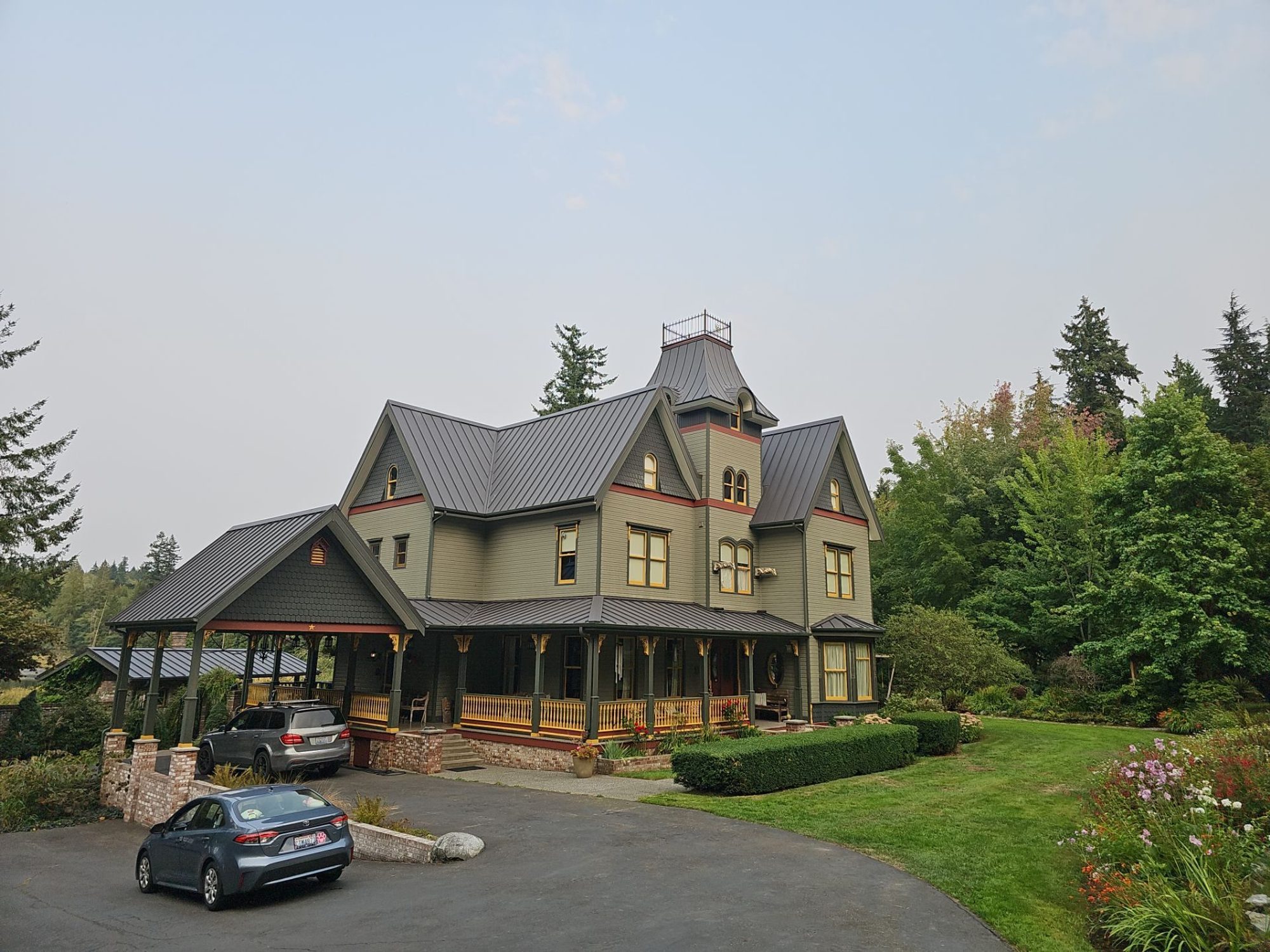 Aerial drone view of completed Black Carbon standing seam metal roof on Stanwood, WA home by Amor Roofing
