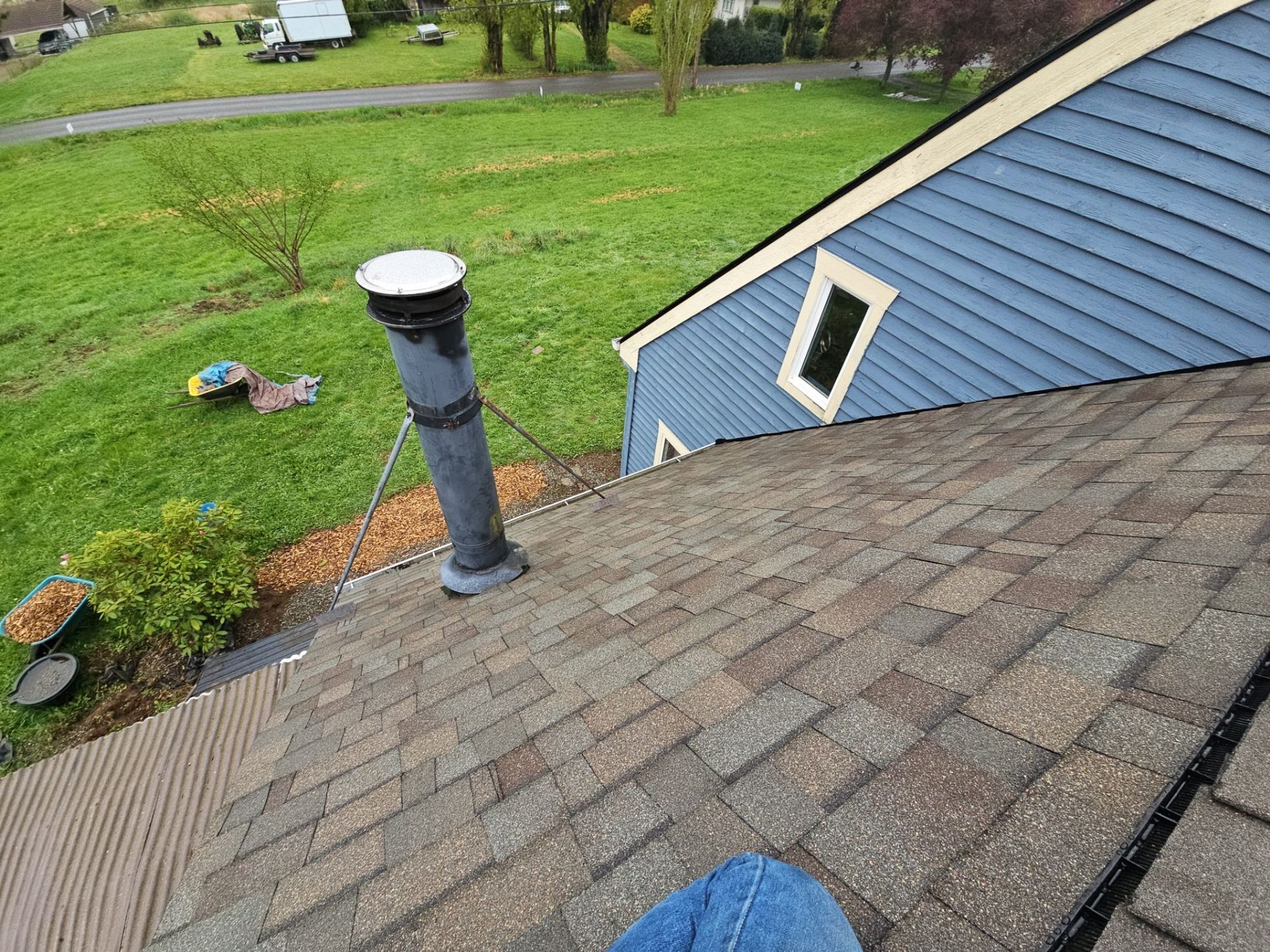 Finished Malarkey Vista Natural Wood asphalt shingle roof over the dormer with pipe vent and the lawn below, Snohomish, WA, by Amor Roofing