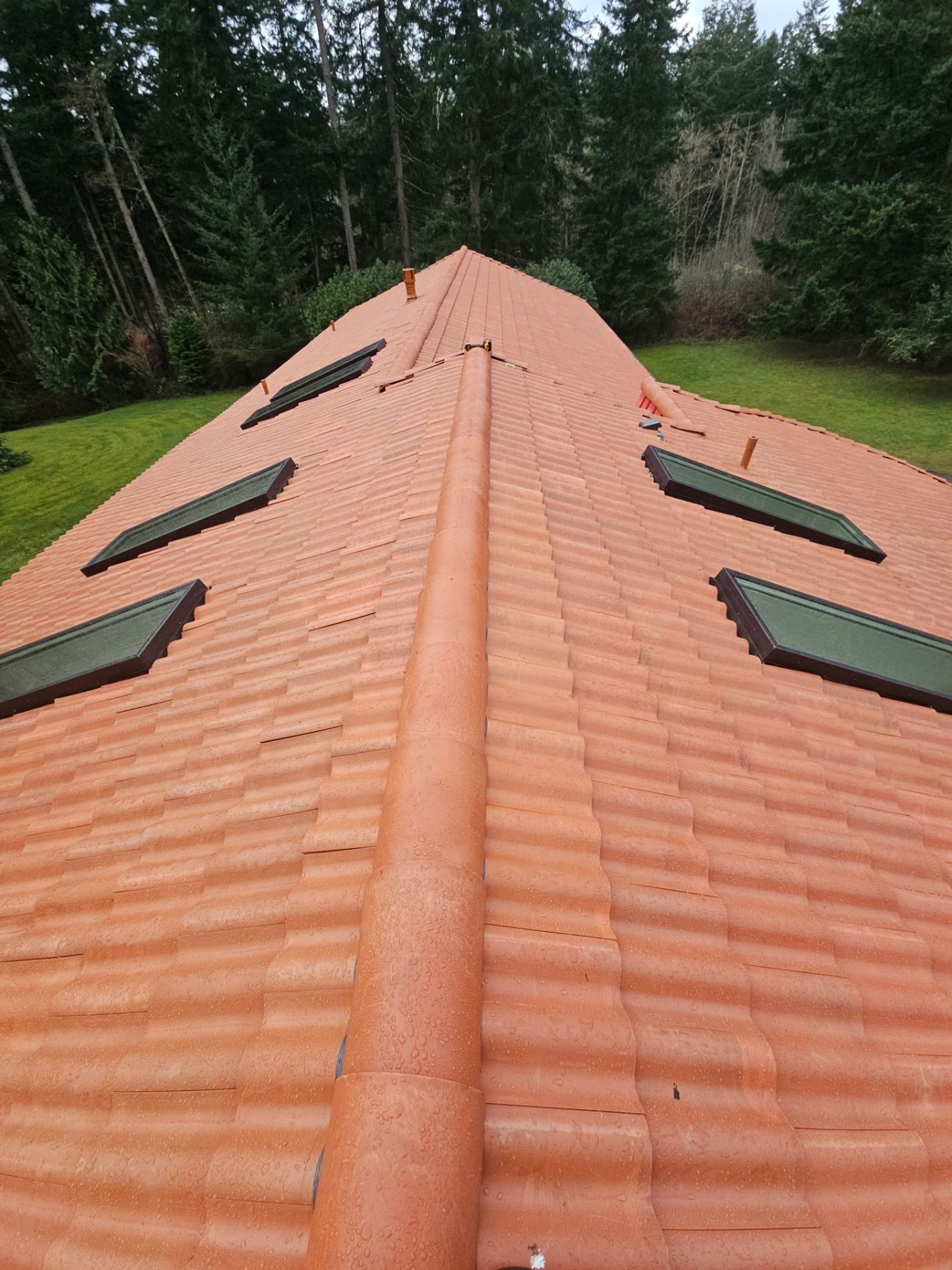 Aerial drone view of completed Antique Clay Brava Spanish barrel tile roof on Camano Island, WA home by Amor Roofing