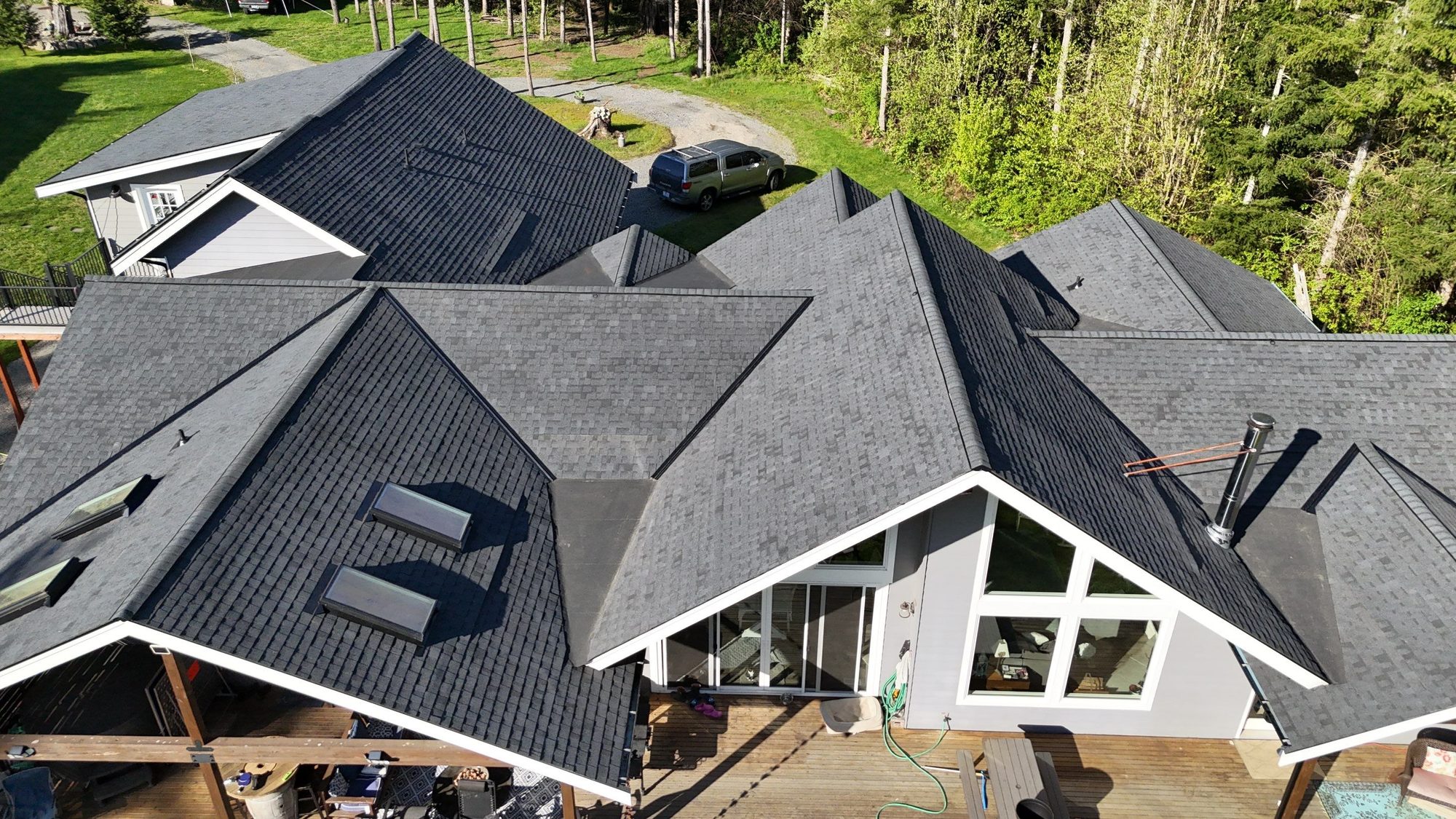 Rear aerial of the finished asphalt roof over the great-room window wall, Lake Stevens, WA