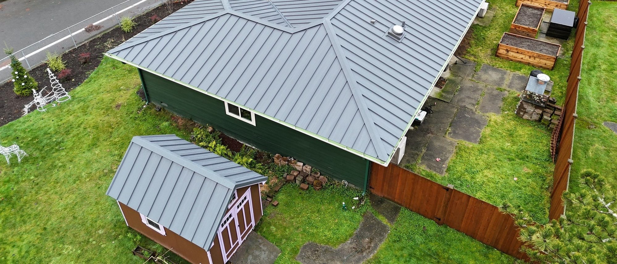 Aerial view across the hip and ridge of the Cascade Gray standing seam metal roof, Woodinville, WA
