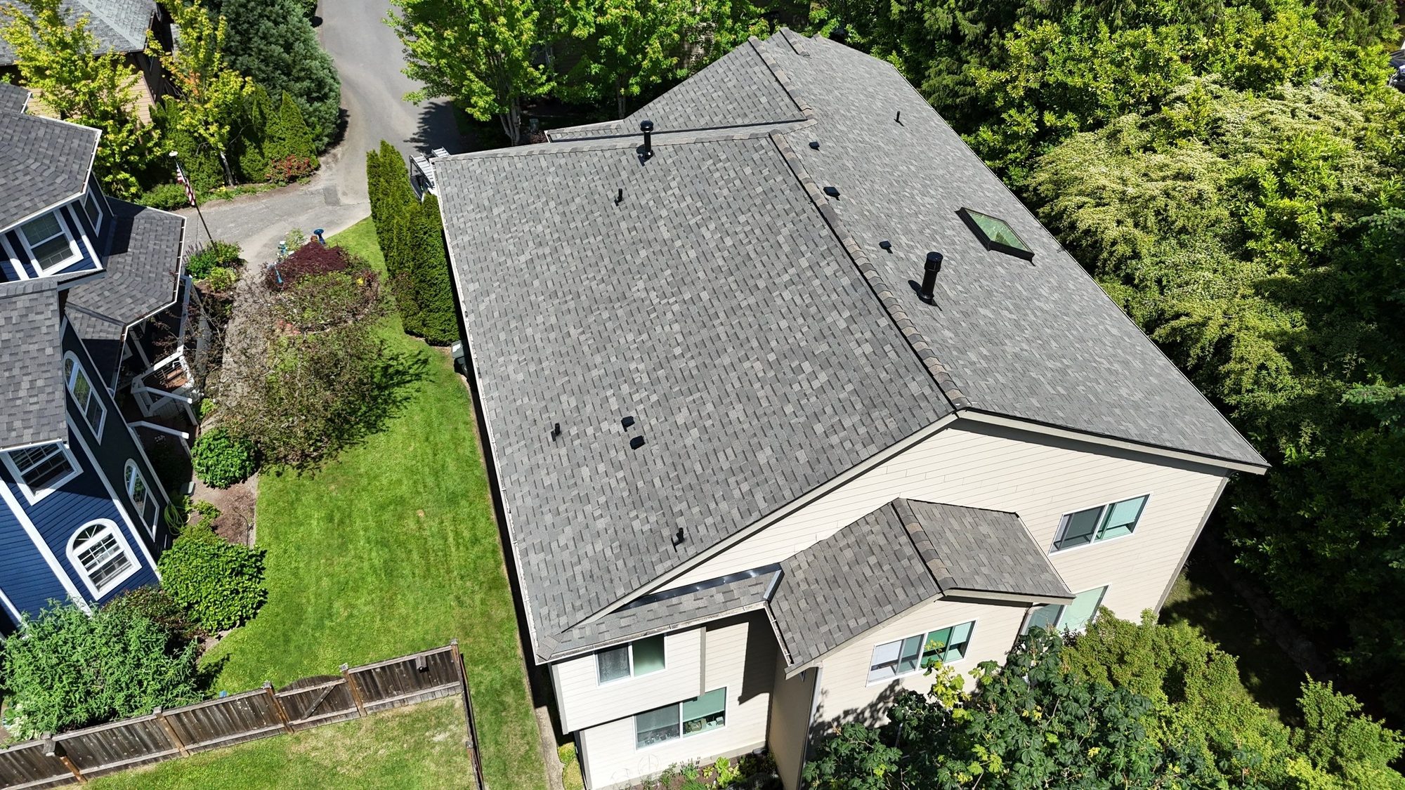 Amor Roofing Weathered Wood asphalt roof in Kenmore, drone front overhead road