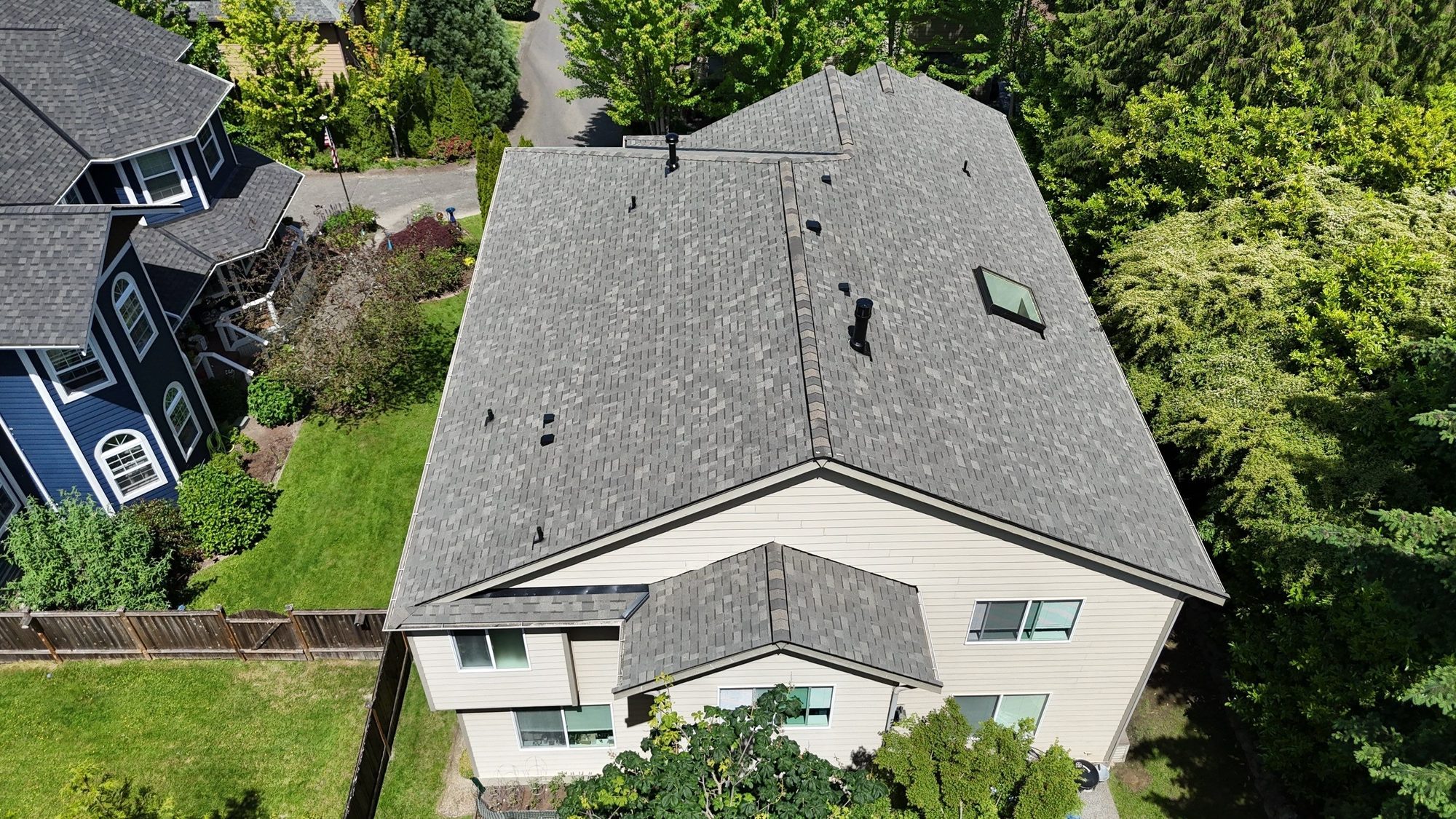 Amor Roofing Weathered Wood asphalt roof in Kenmore, drone front overhead skylight