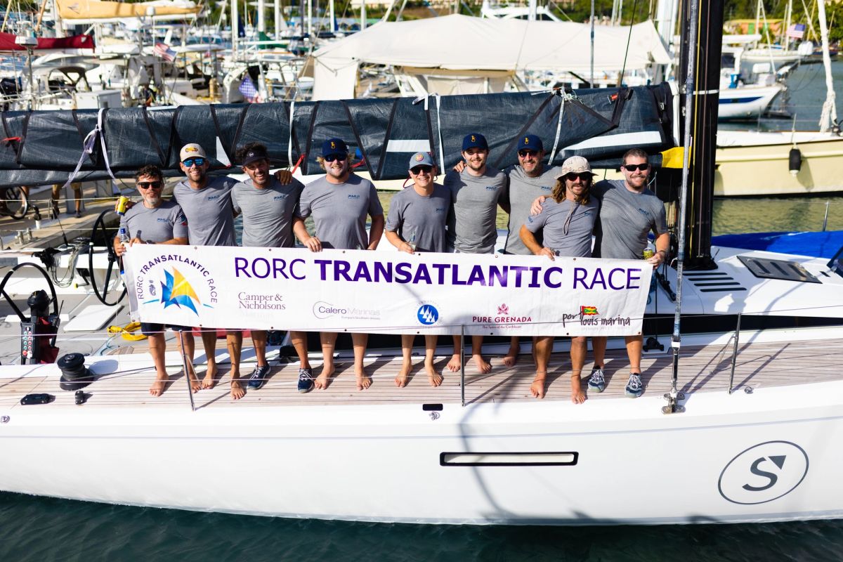 Pimu crew in Grenada with the RORC Transatlantic Race banner