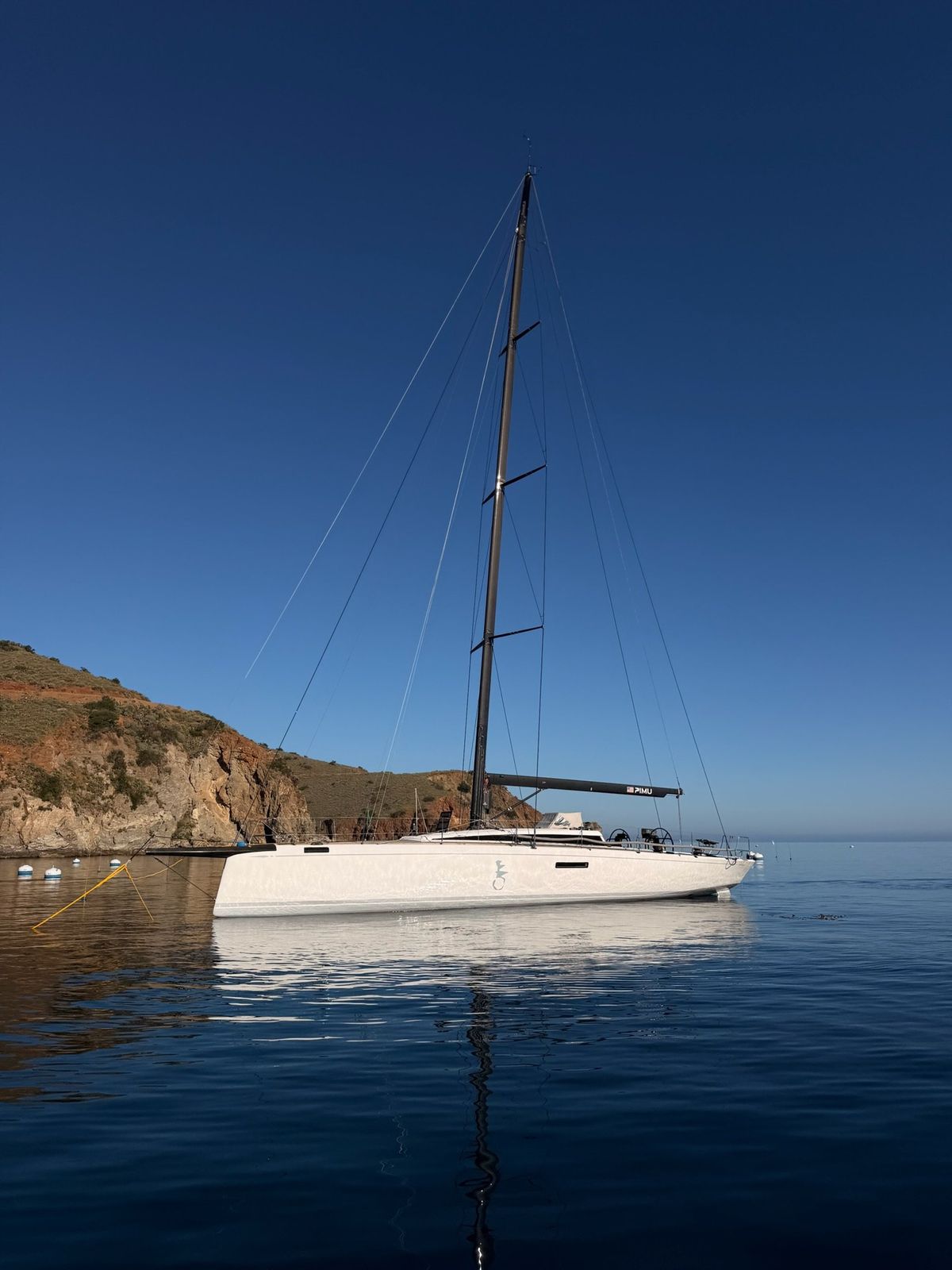 Pimu at anchor in a calm cove