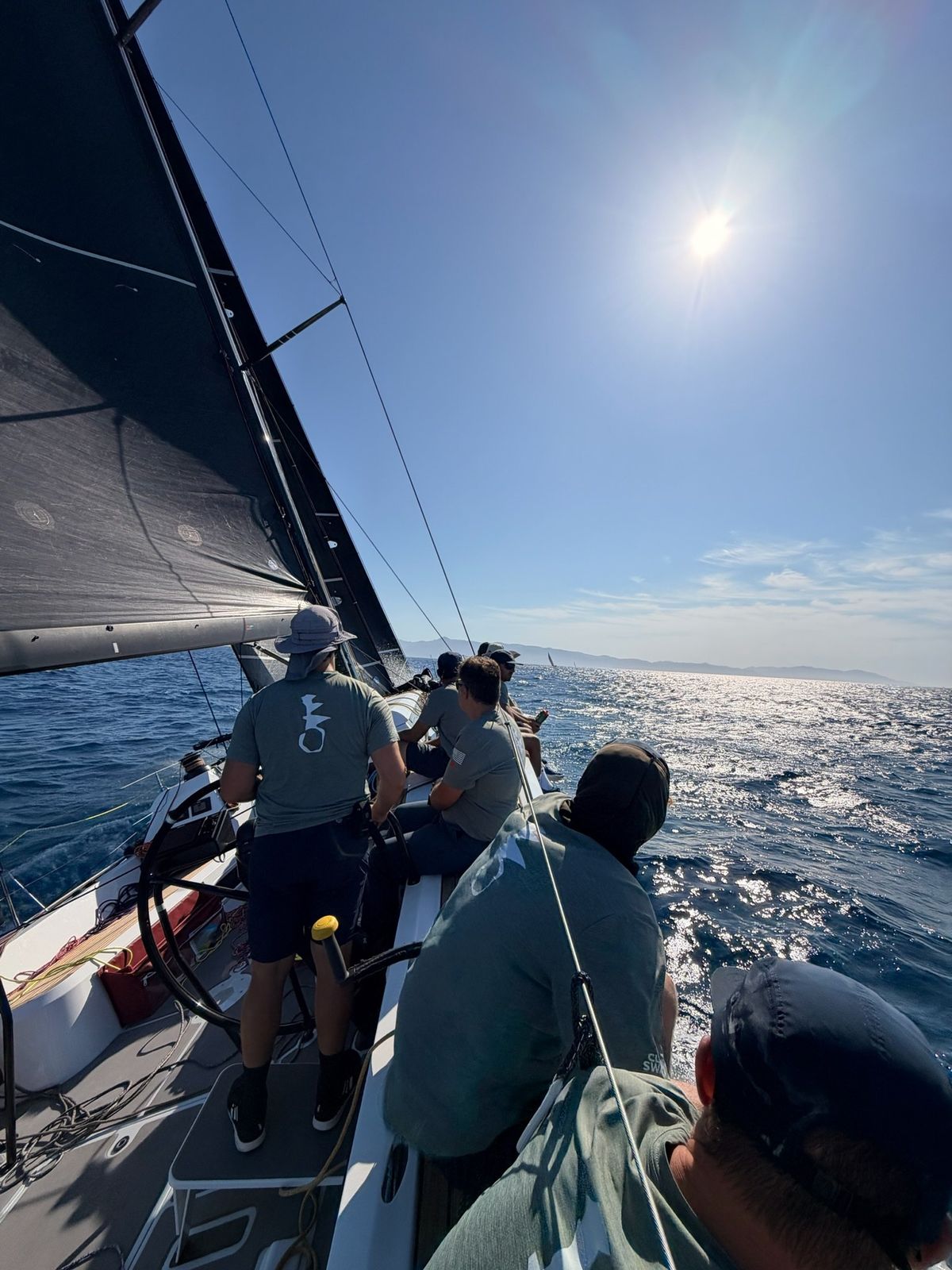 Crew at the helm offshore
