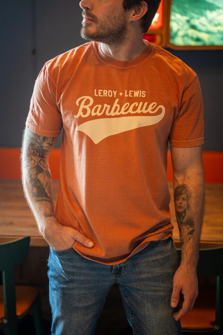 Burnt orange tee with LeRoy + Lewis Barbecue in cream script