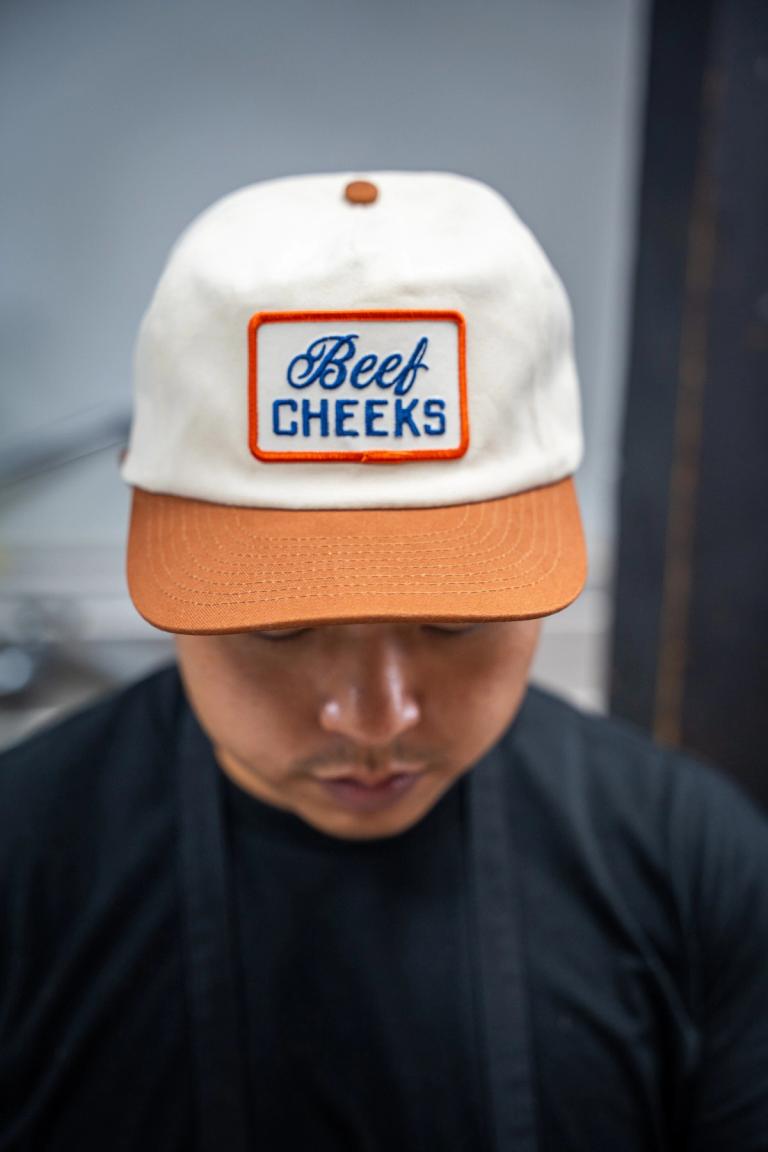 Cream and burnt orange cap with a Beef Cheeks patch