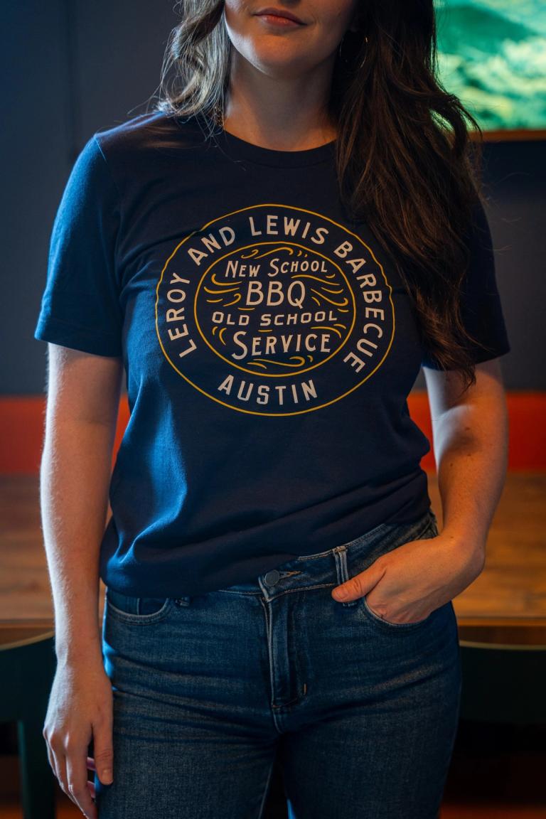 Navy tee with the round LeRoy and Lewis seal across the chest