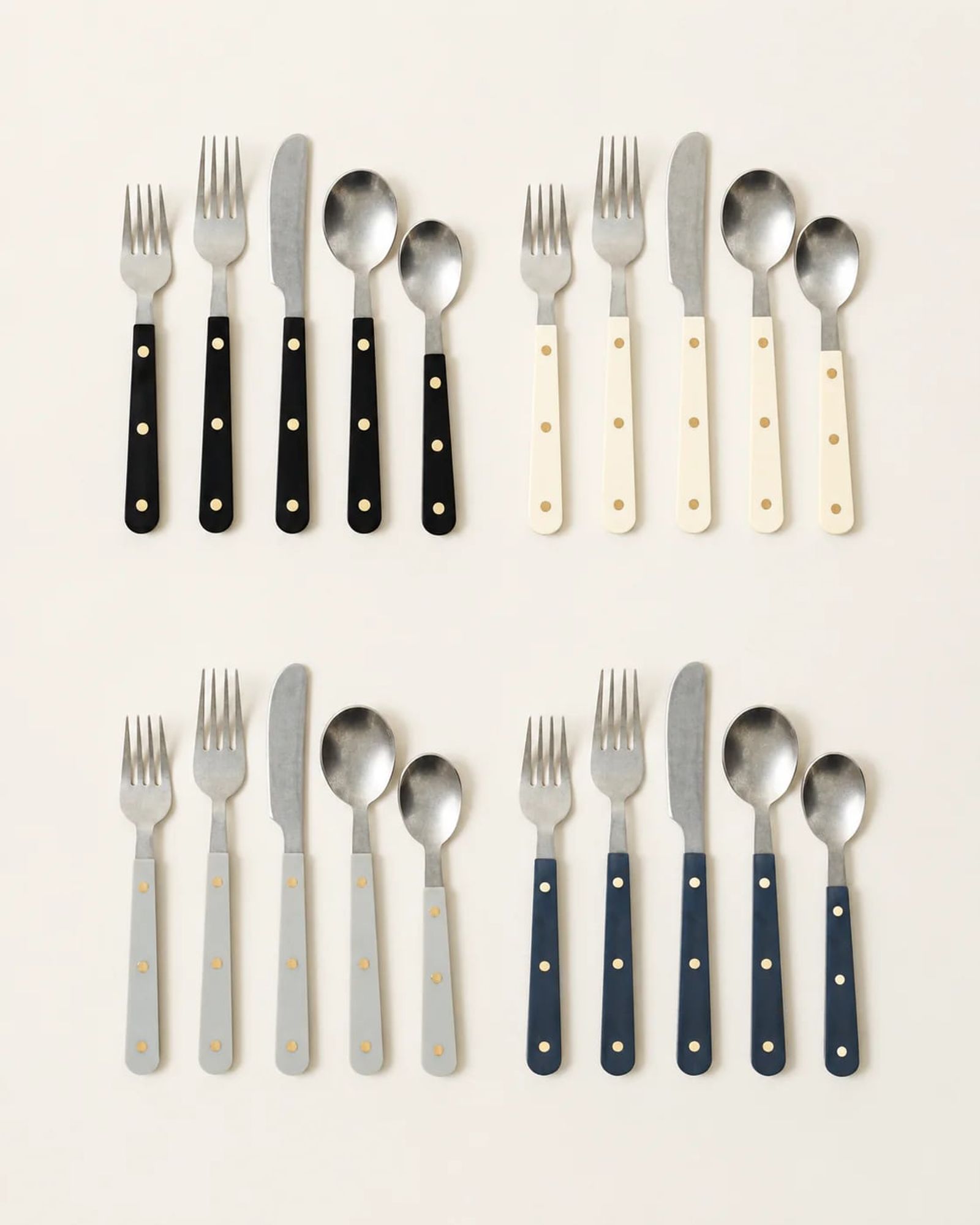 Handmade flatware sets with black, cream and brushed-steel handles