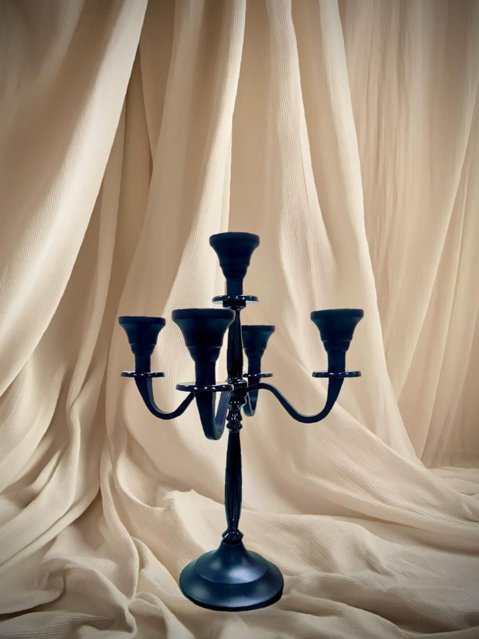 Navy enamel five-arm candelabra styling a curated tabletop