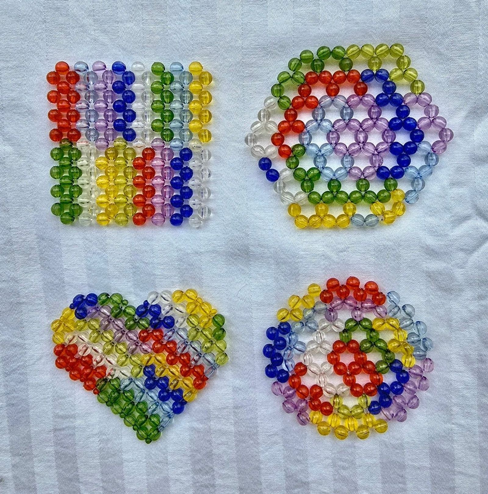 Hand-beaded glass coasters in assorted patterns
