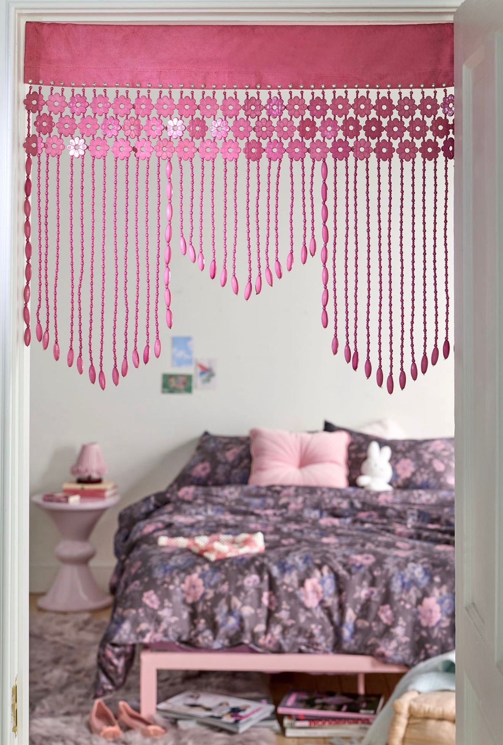 Pink hand-beaded valance hung in a doorway