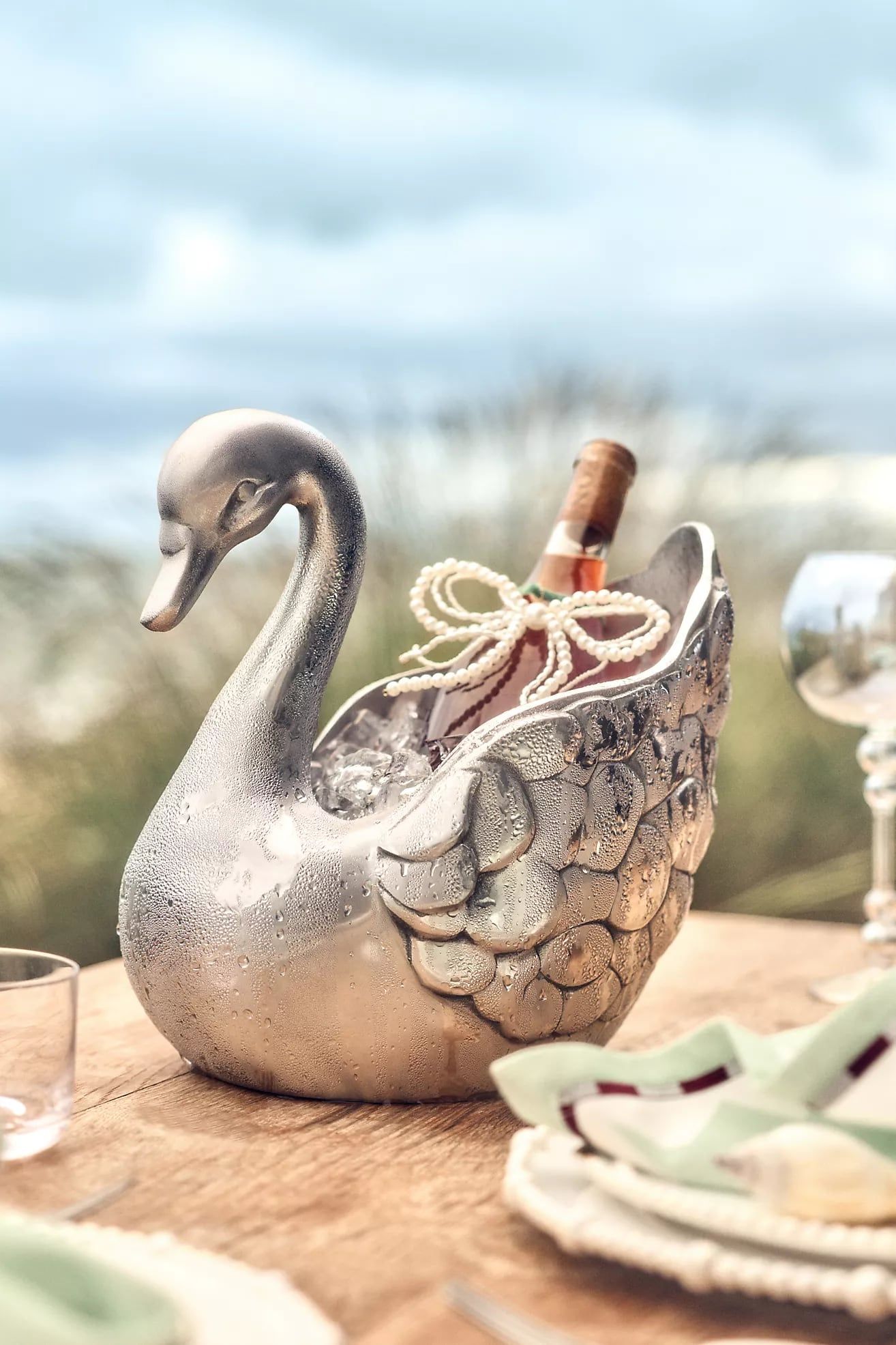 Cast metal swan planter on a garden wall