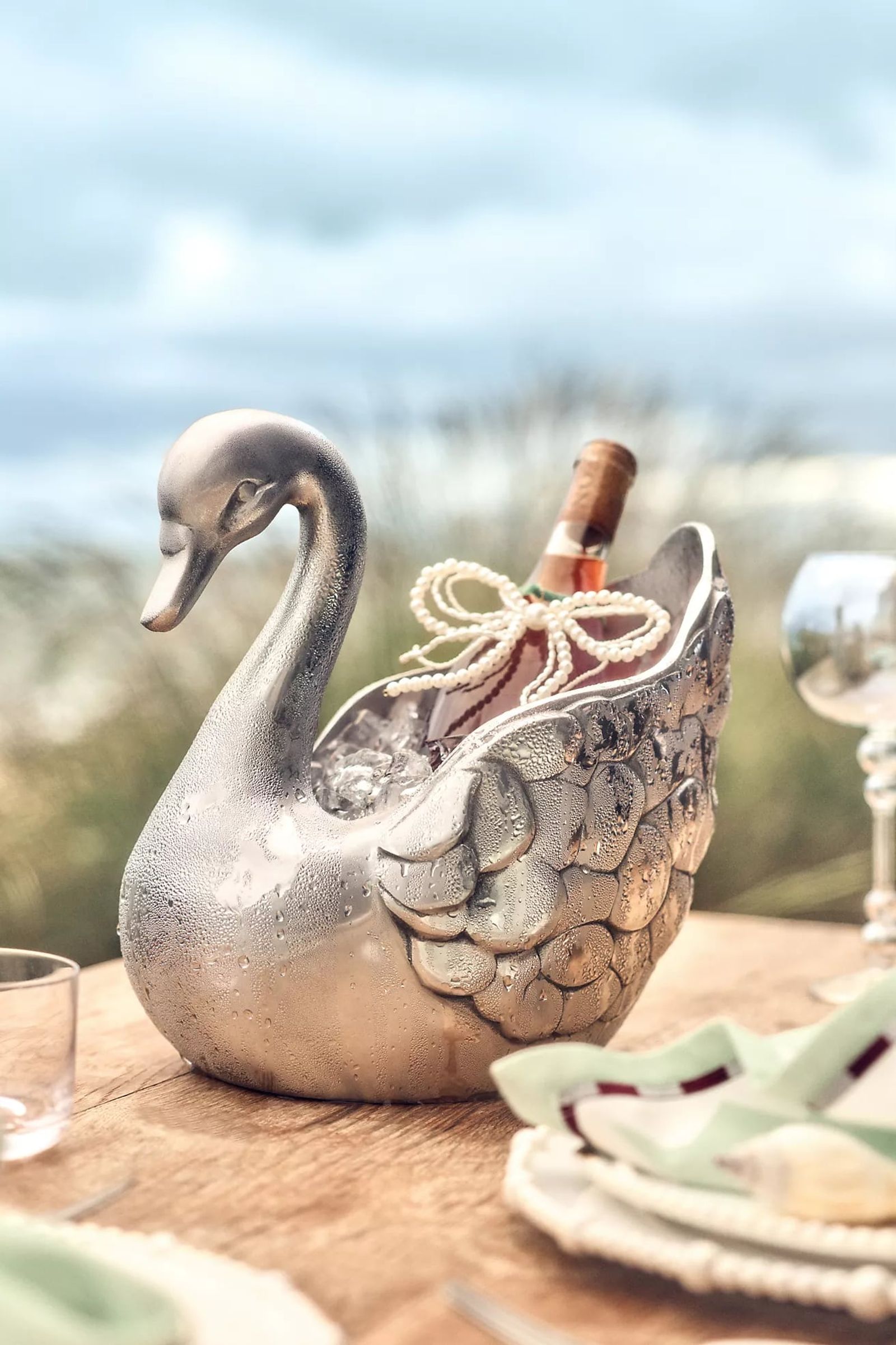 Cast metal swan planter on a garden wall