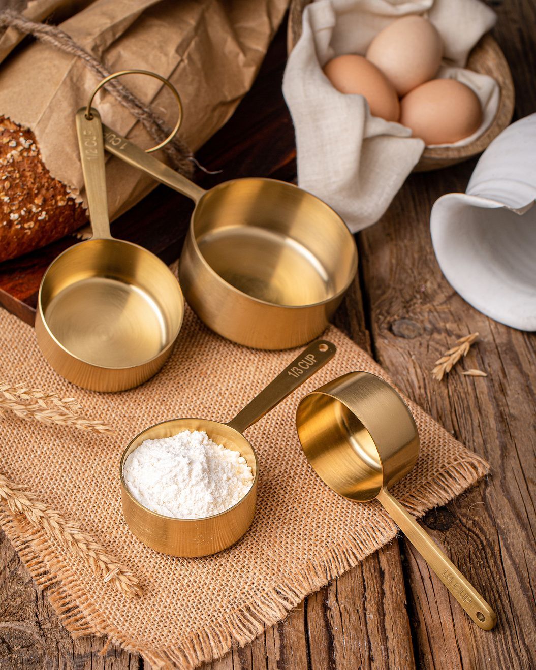 Brushed-gold measuring cups in a baking scene
